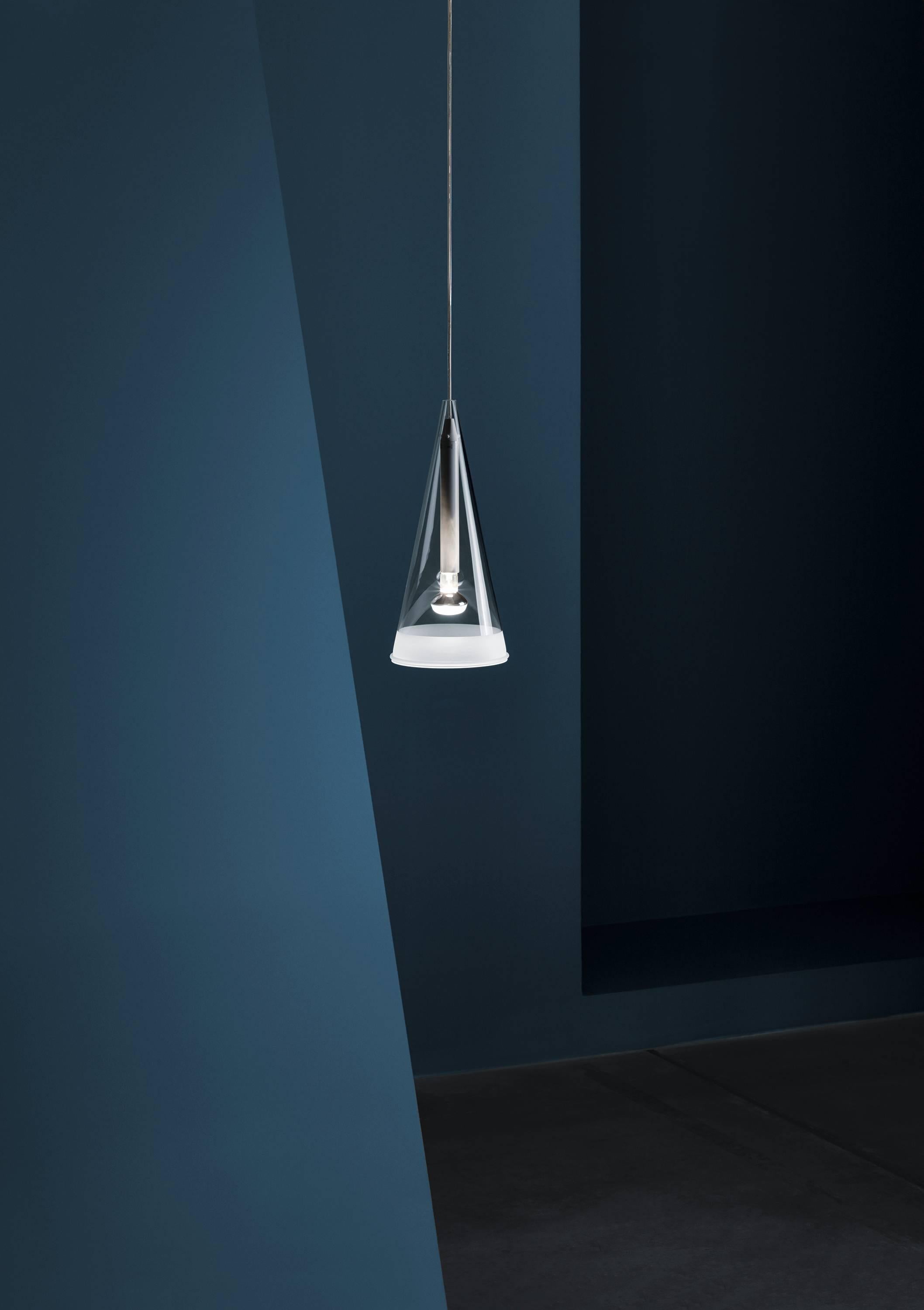 An edgy and industrial look with a sophisticated finish, the Fucsia 1 by Achille Castiglioni is pendant lighting as only he could imagine it. Offering direct and diffused light, the conical blown glass diffuser is finished with a 1.5