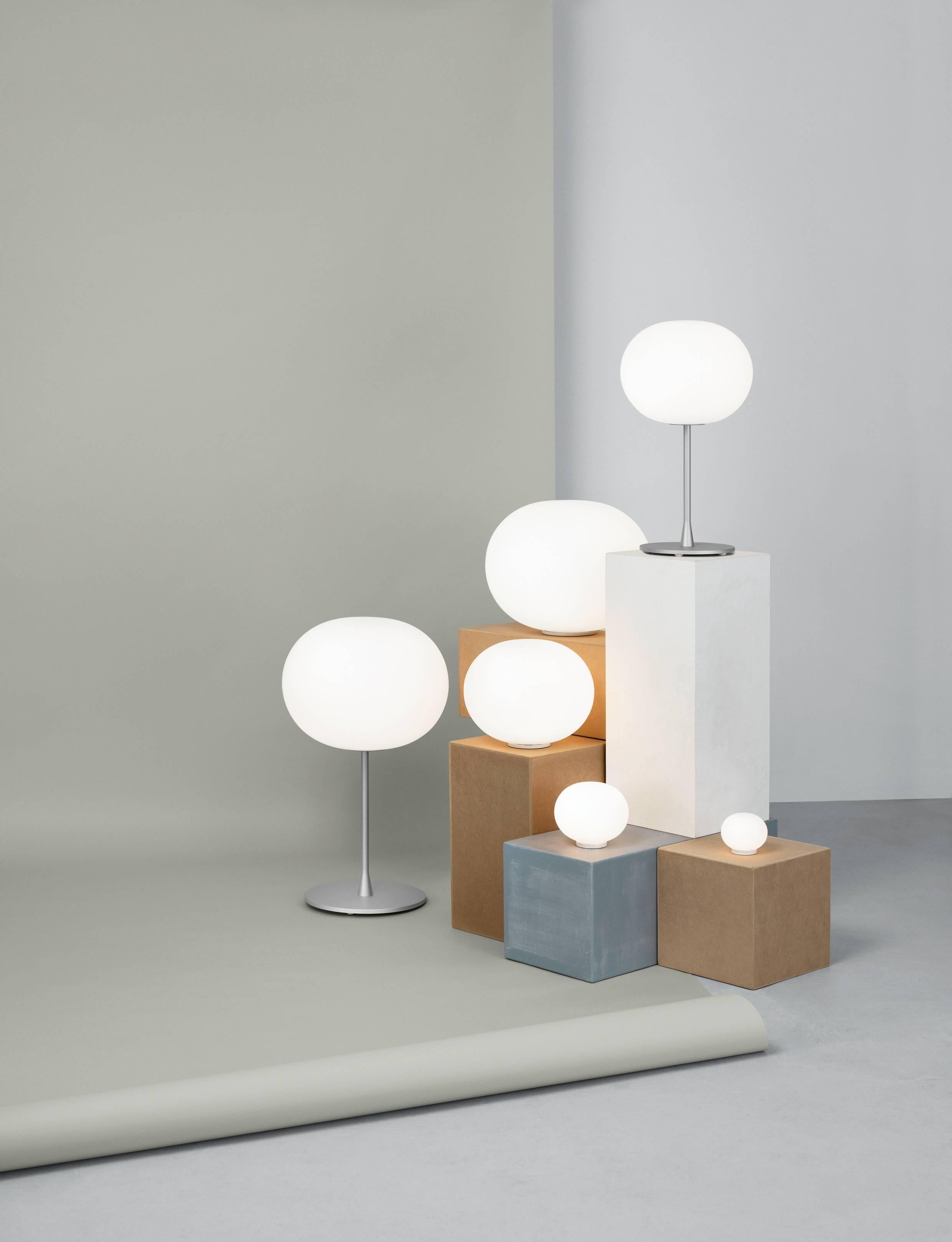 Flos Glo-Ball T1 Halogen Table Lamp by Jasper Morrison
Part of the popular Glo Ball Series, the Glo Ball Basic was created in 1998 by artist Jasper Morrison to invoke the radiant calm of a full moon. This unique table lamp has a white acid-etched