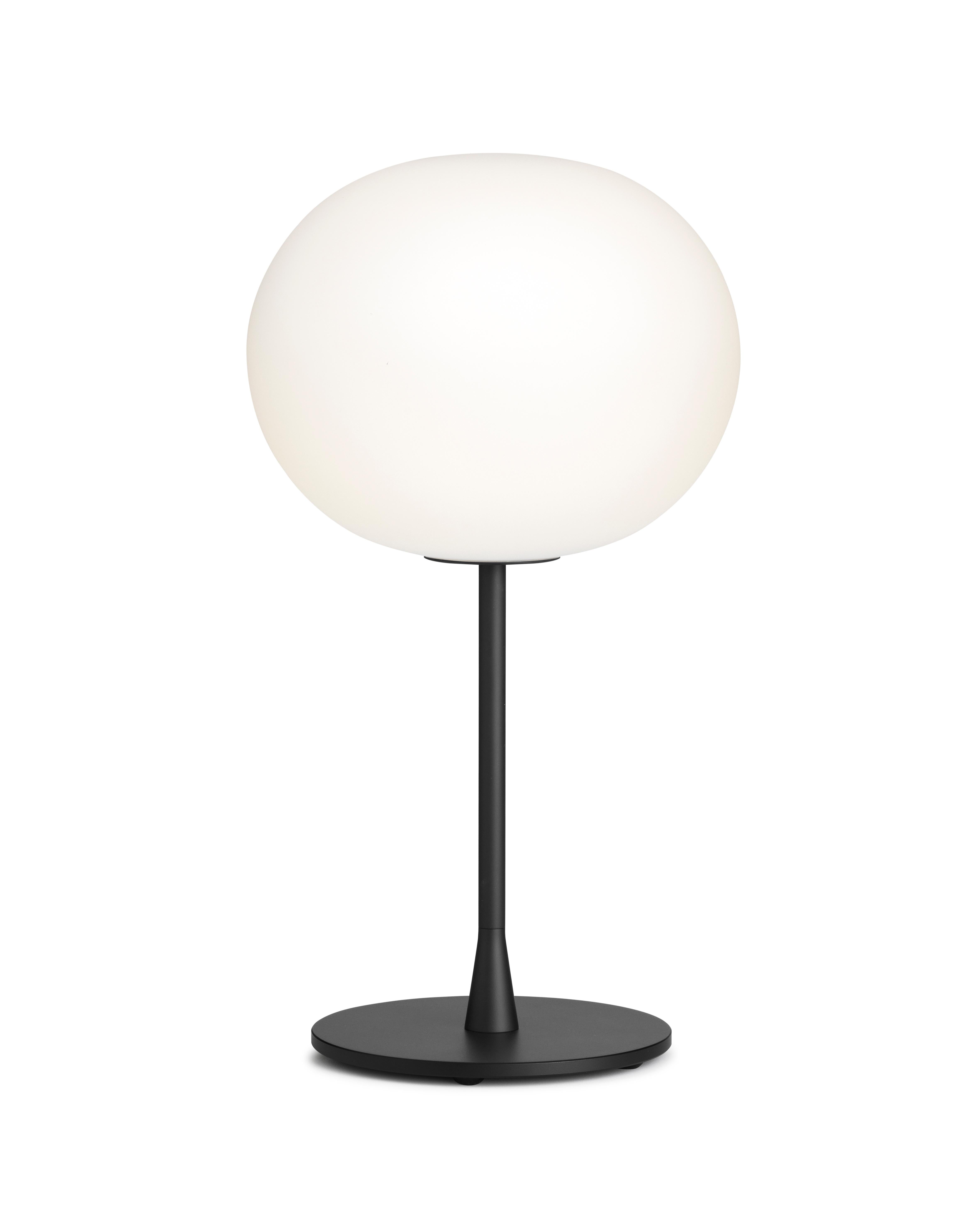 FLOS Glo Ball T1 Table Lamp in Black, by Jasper Morrison

Part of the popular Glo-Ball Series, the Glo-Ball T was created in 1998 by artist Jasper Morrison to invoke the radiant calm of a full moon. This unique table lamp has a white acid-etched