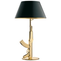 Lampe de bureau AK47 de la collection FLOS Guns en or de Philippe Starck