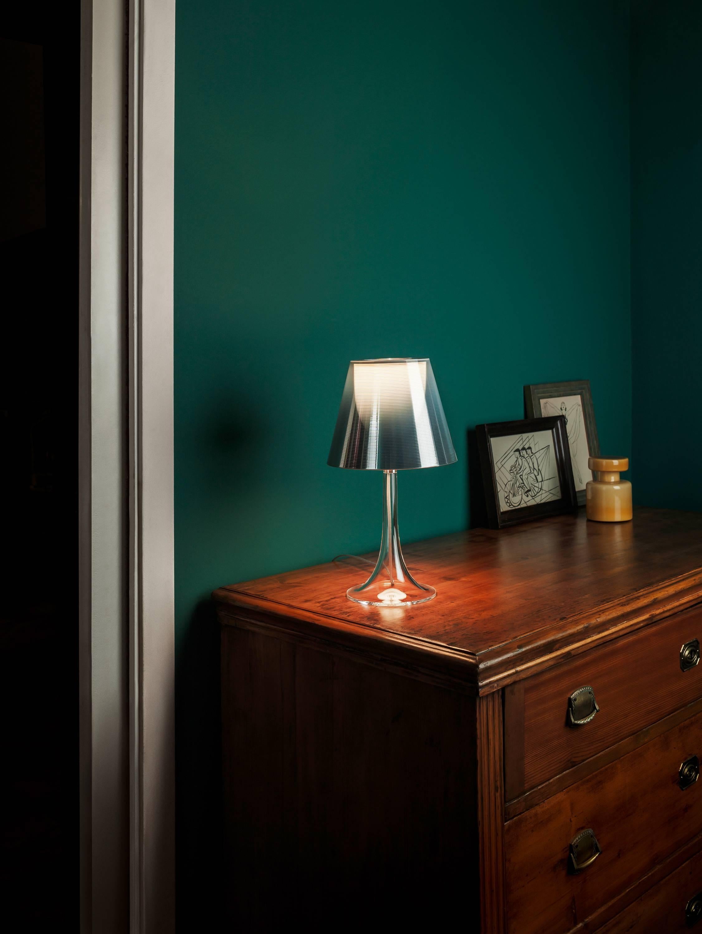 Created by innovative design master Philippe Starck, the Miss K table lamp brings a delightful duality to its work. When unlit, its transparent PC (polycarbonate) outer diffuser—which is internally finished with a high vacuum aluminization