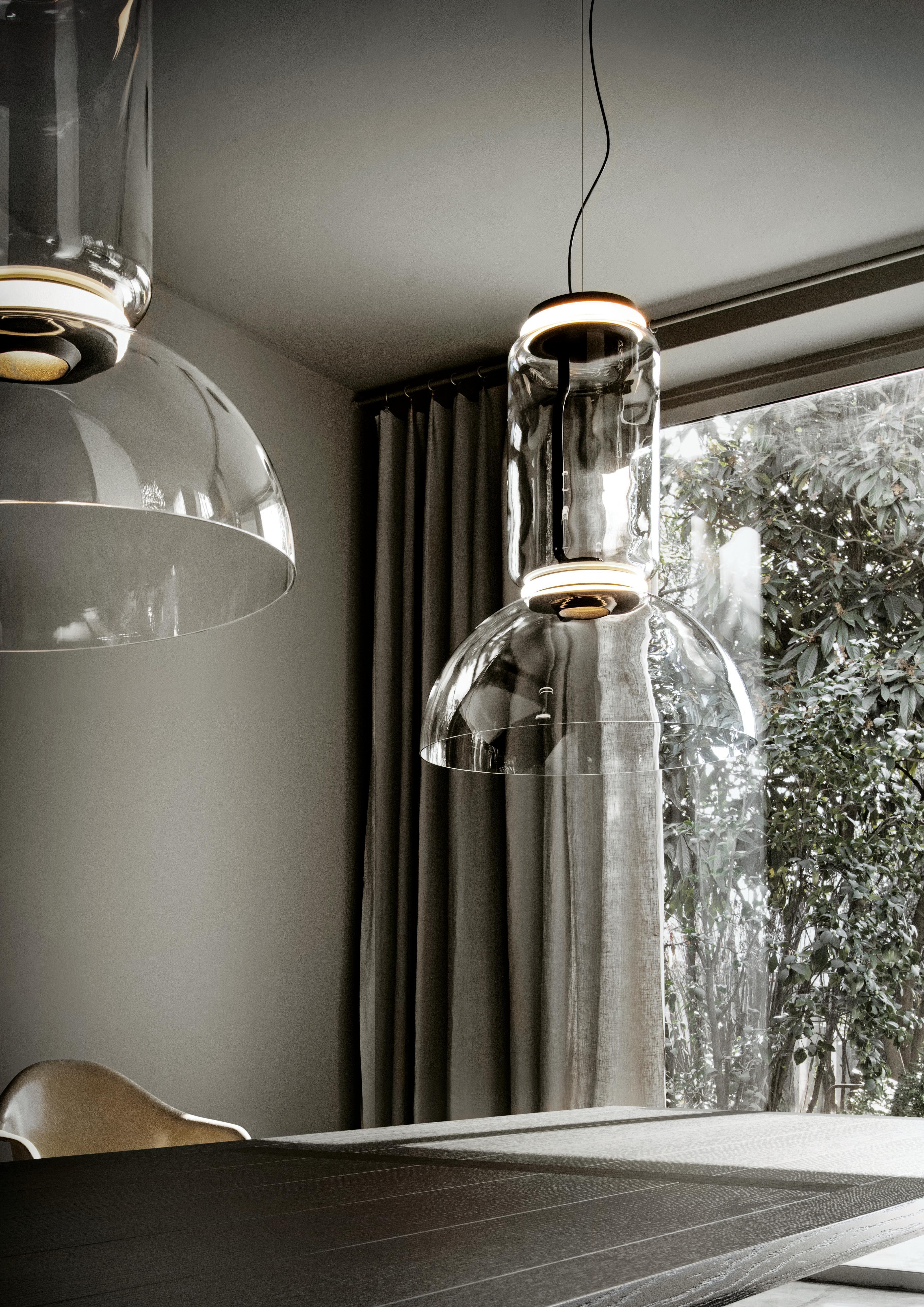Noctambule LED dimmable pendant light with bowl shade, created by renowned designer Konstantin Grcic for Flos, is an innovative lighting system that comes in an array of artful designs. A transparent hand-blown glass cylinder, surrounded on both top