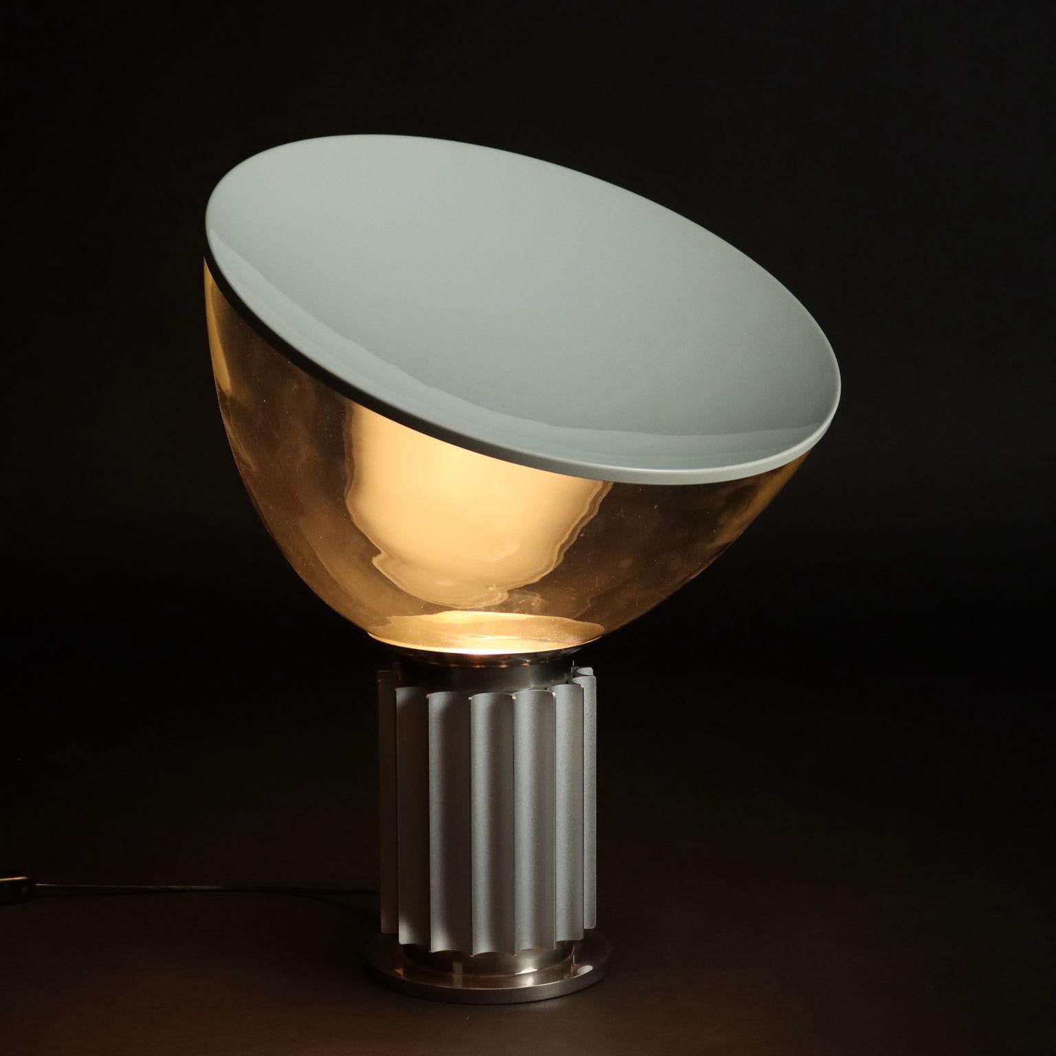 Table lamp with adjustable diffuser for indirect light; base in metal and chromed aluminum, glass and aluminum diffuser.