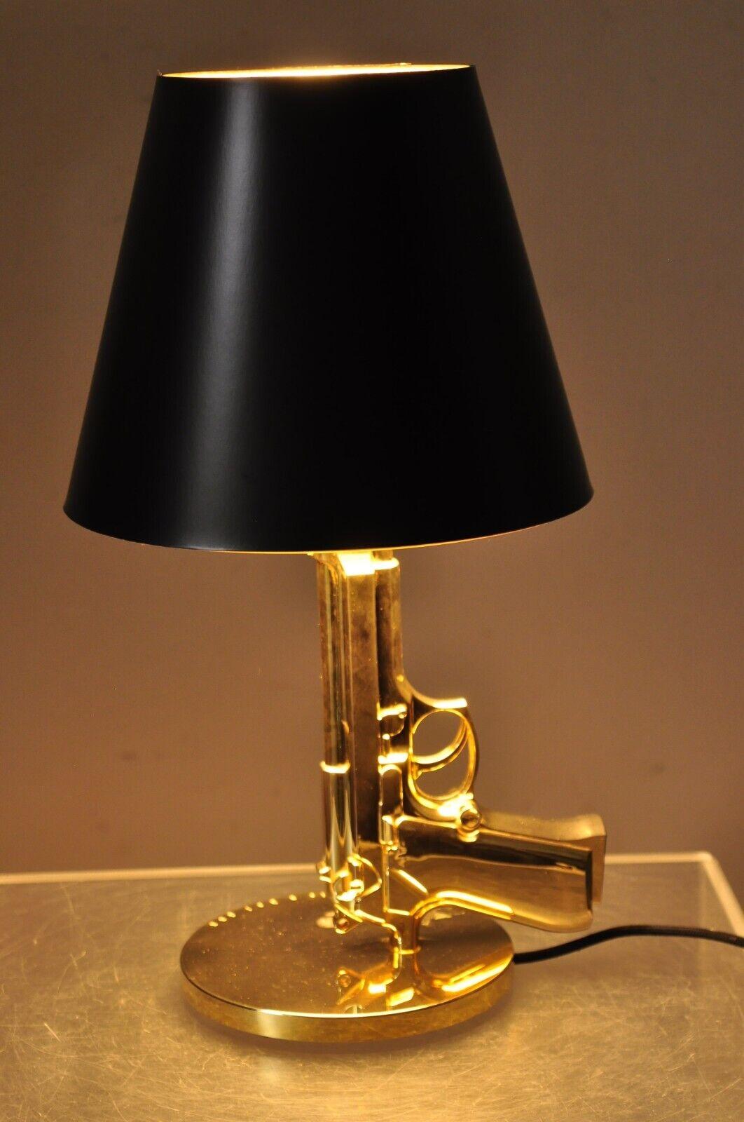 Flos with Starck Phillpe Starck Gold Bedside Gun Table Lamp with Shade. Item featured is from the 