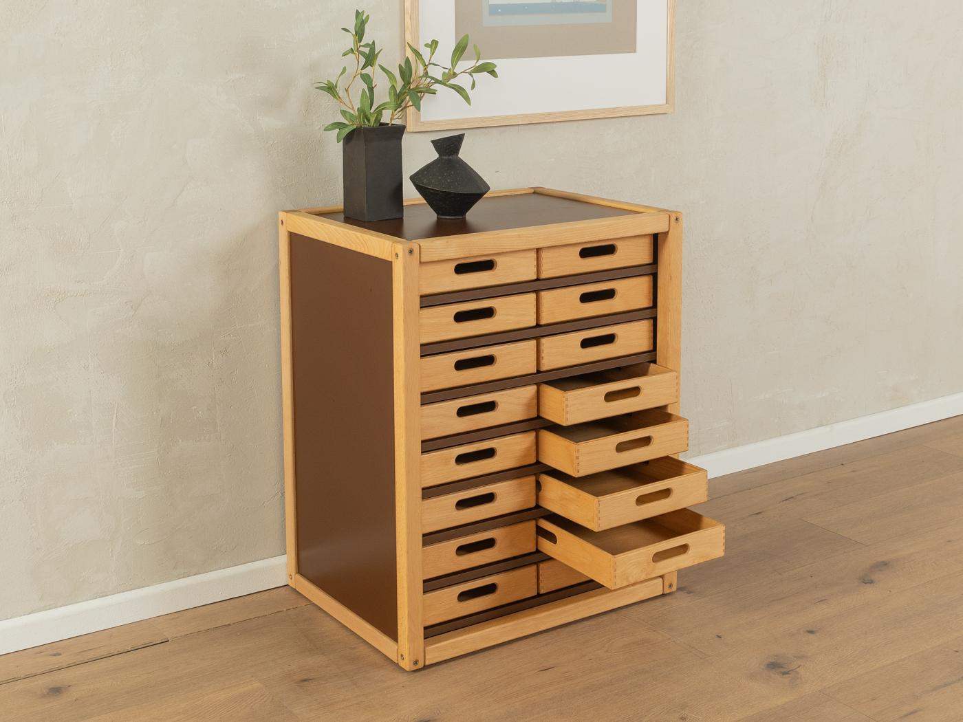Profilsystem by Flötotto from the 1970s. Container with 16 drawers. The frame and drawers are made of solid beech wood. Original HPL coating in brown. 

Quality Features:
very good workmanship
high-quality materials
mortise & tenon solid wood