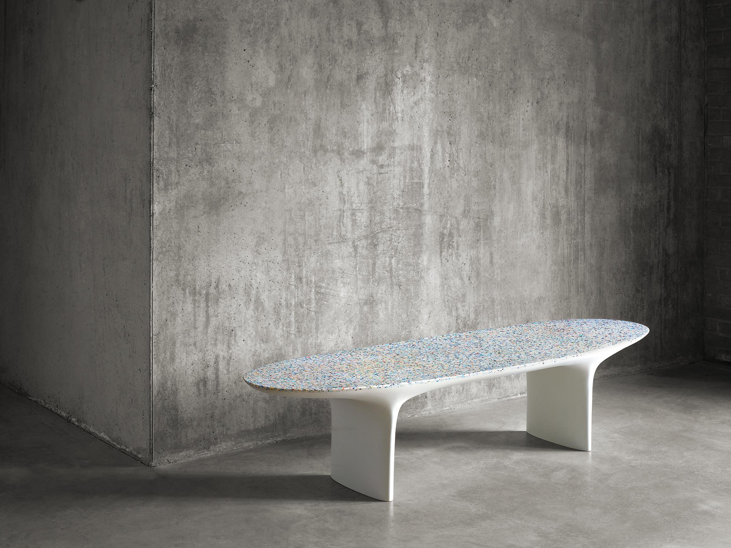 The Flotsam bench is produced using the innovative ocean terrazzo material developed by Brodie Neill using reclaimed and recycled fragments of ocean plastic. Cast completely as a singular piece by artisans in the UK, the bench seat takes its name