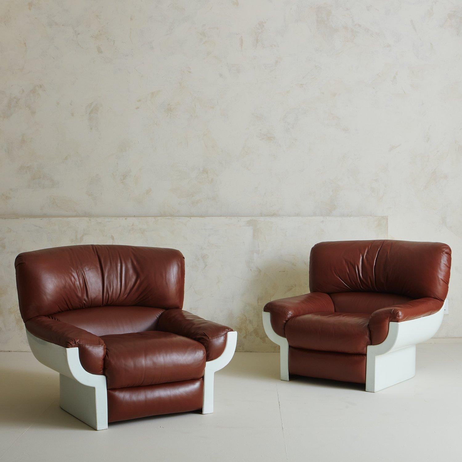 Two ‘Flou’ lounge chairs designed by Augusto Betti for Habitat Faenza in 1968. These chairs have sculptural white fiberglass frames and feature original cognac leather upholstery. Sourced in Italy. Two Available, Priced Individually.

Augusto Betti