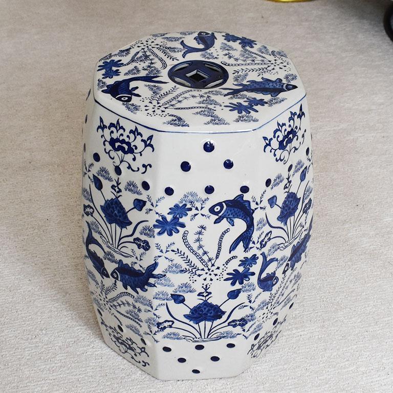A fabulous flow blue traditional English chinoiserie ceramic garden stool. Great for use as a stool for extra seating, a small side table, or as a plant stand. This lovely stool is created from ceramic and features a glazed floral motif in blue and