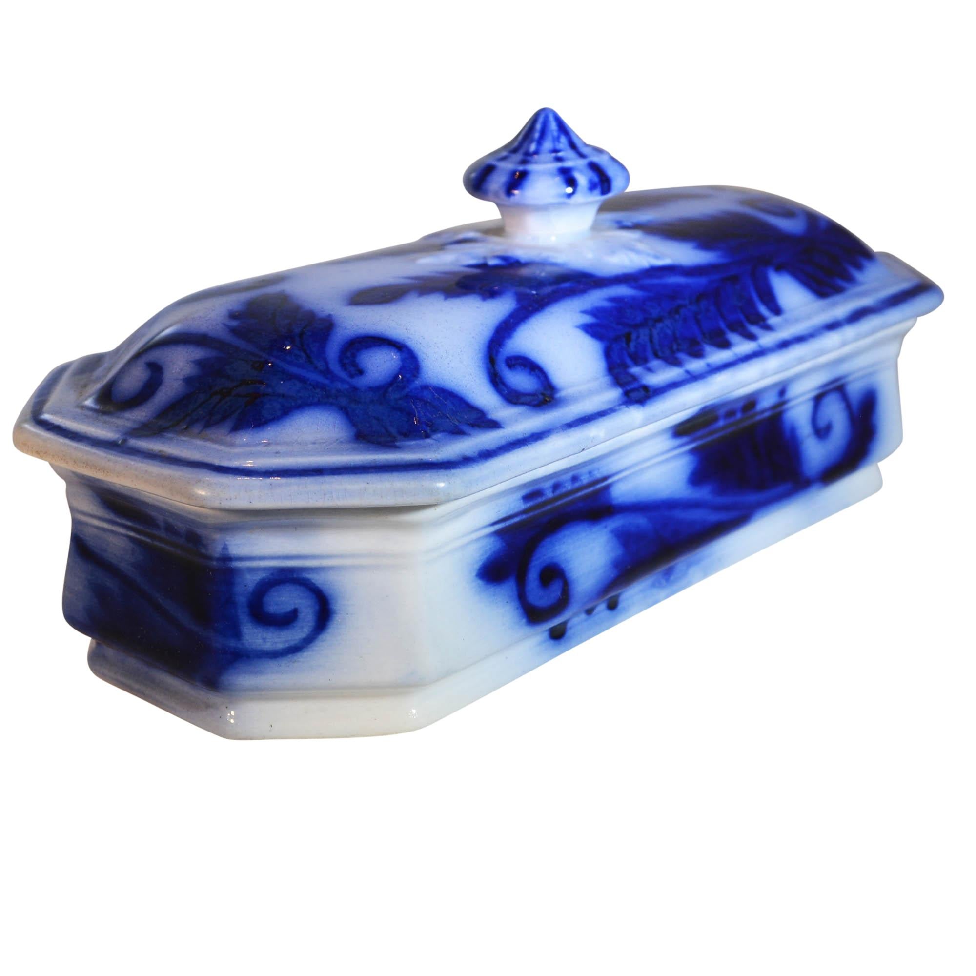 Beautiful blue flow toothbrush holder is highly decorated with the design. The lid has a raised dimensional design surrounding the lift knob which makes this toothbrush holder a rare find. The lid's knob is decorated as well. This type of piece is