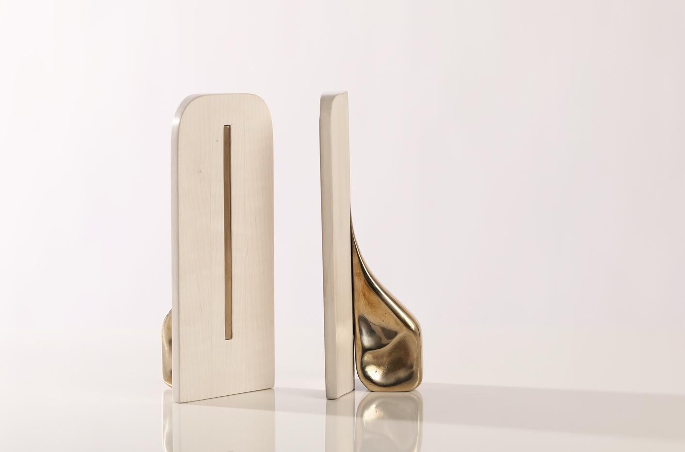 Carved wood and cast bronze bookend. 
Available in:
Ebonized Walnut 
Bleached Maple 
Natural Walnut