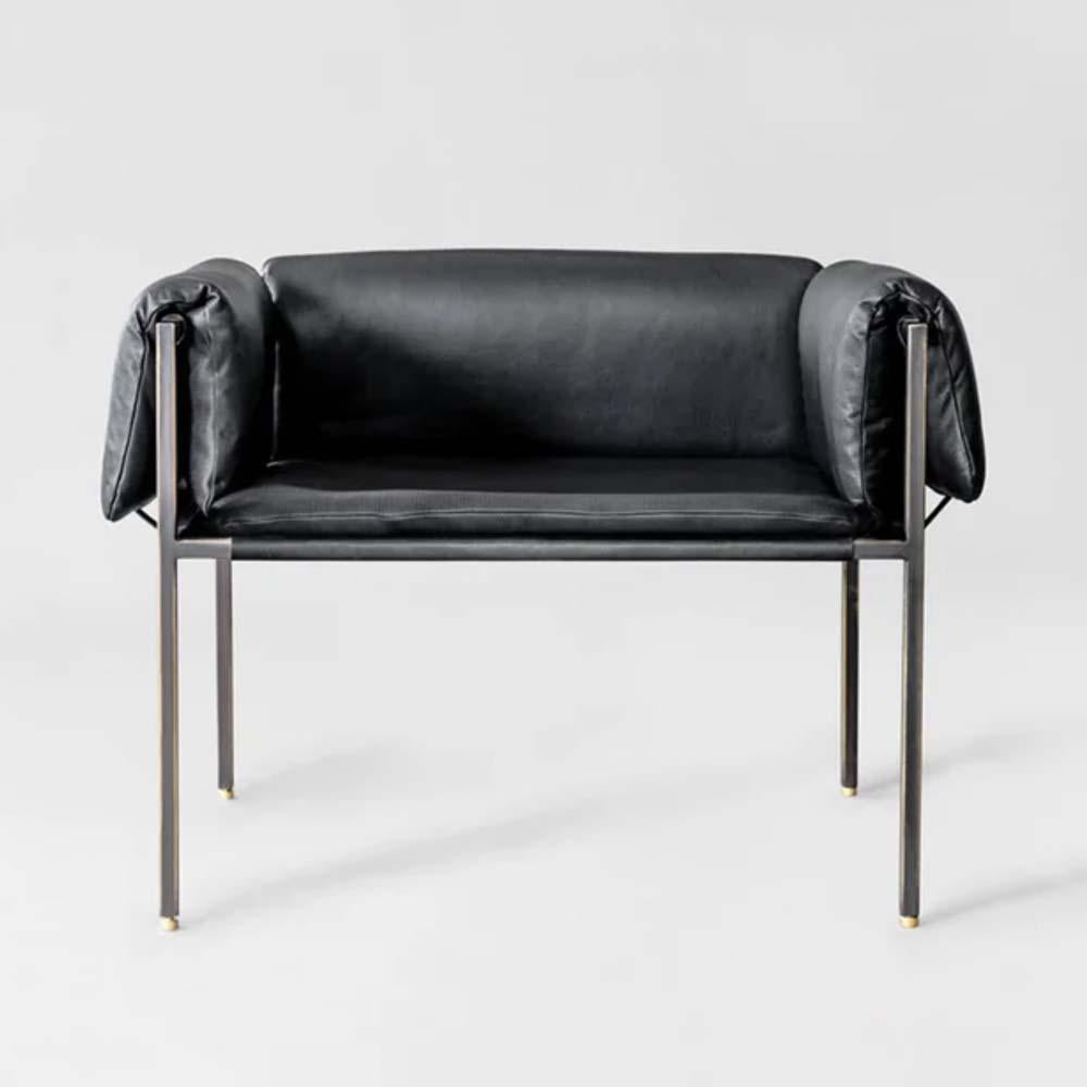 This armchair is made with a blackened steel designed frame covered by a lamborghini black leather. The piece is designed with the influence of swedish minimalist and modern design, bringing sophistication and comfort to the furniture. The black