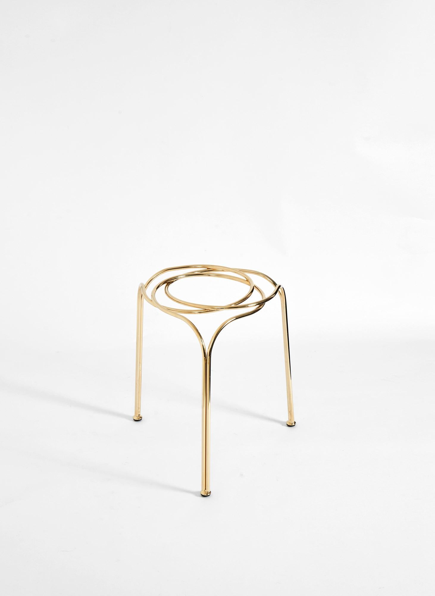 An element, a metal wire that is the stretch that draws a circle in space. Three elements, three circles, integrate and inerpenetrate in a geometric game creating an unexpectedly solid object.
Flow stool or sculpture, by Enrico Girotti, is