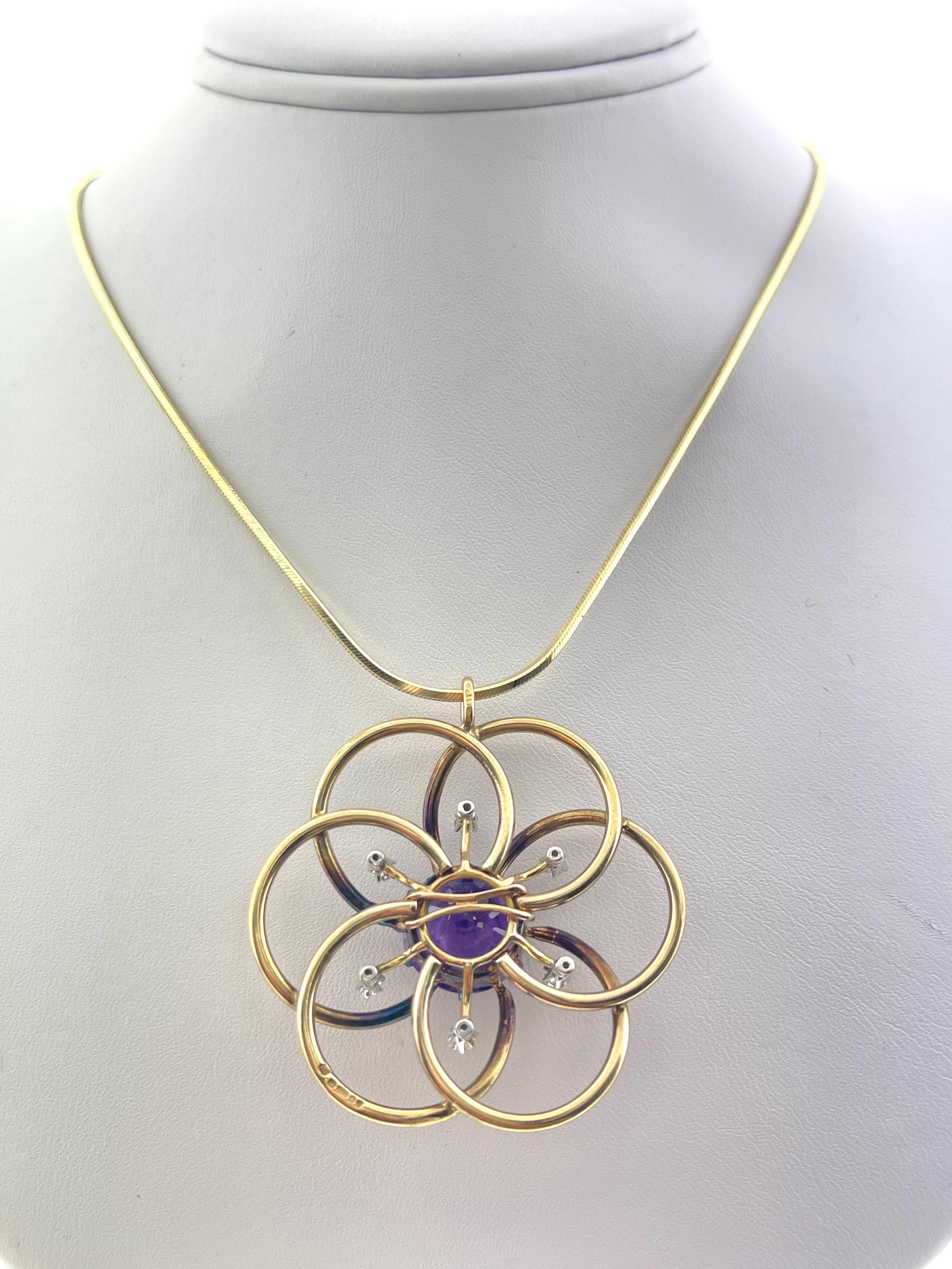 WOW! This pendant will catch everyone's eye ... 

With a round amethyst center and six adorning round diamonds,  this beautiful pendant is looped through thin 24