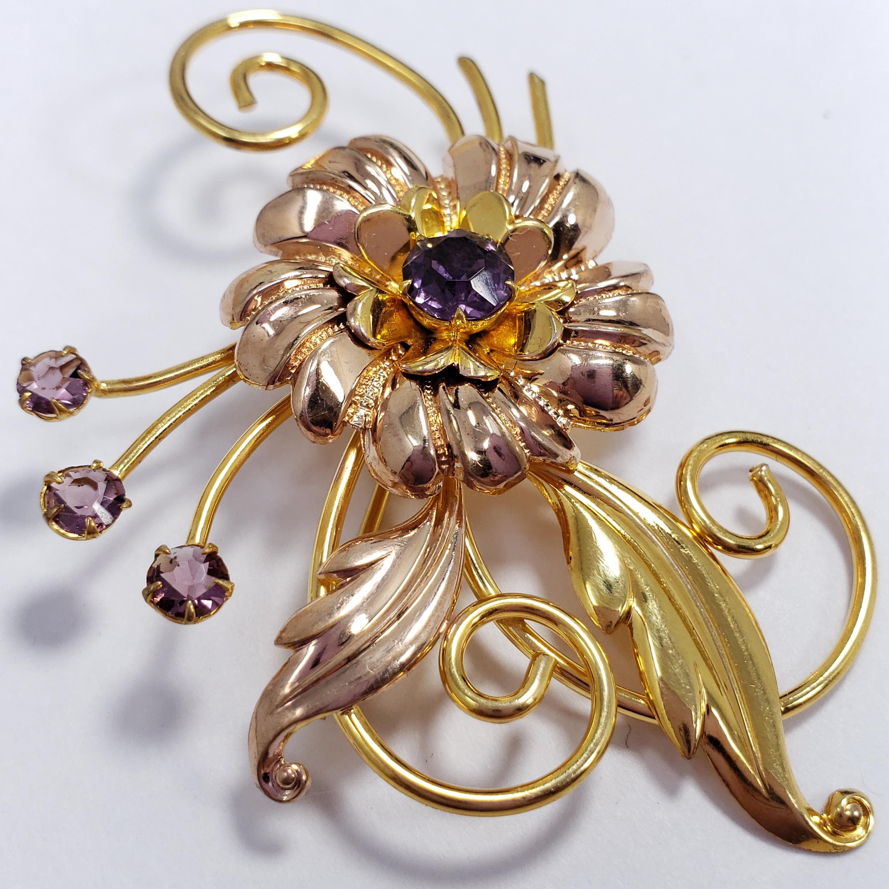 An ornate glowing pin, featuring a golden flower and petals, accented with amethyst crystals. Exquisite!

Hallmarks: 1/20 12K GF, Gold Filled, M