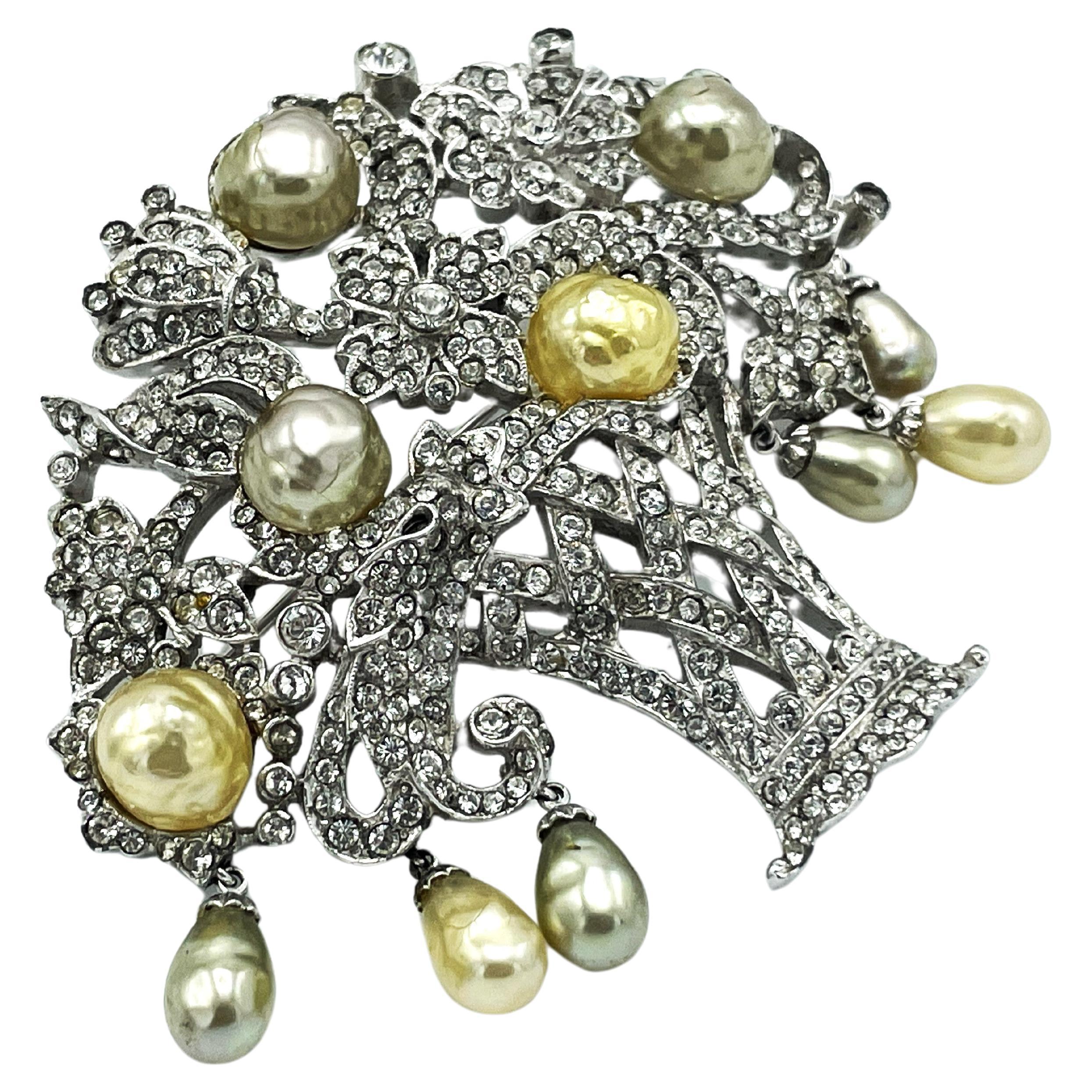 Beautiful basket brooch, with flowers and leaves, fully set with small rhinestones, hanging pearl drops and 5 larger pearls in natural and silver.

Size:
Height 5.5cm
Width 6.5cm
Features:
- Perfect condition - nothing missing.
- Rhodium 
- Early