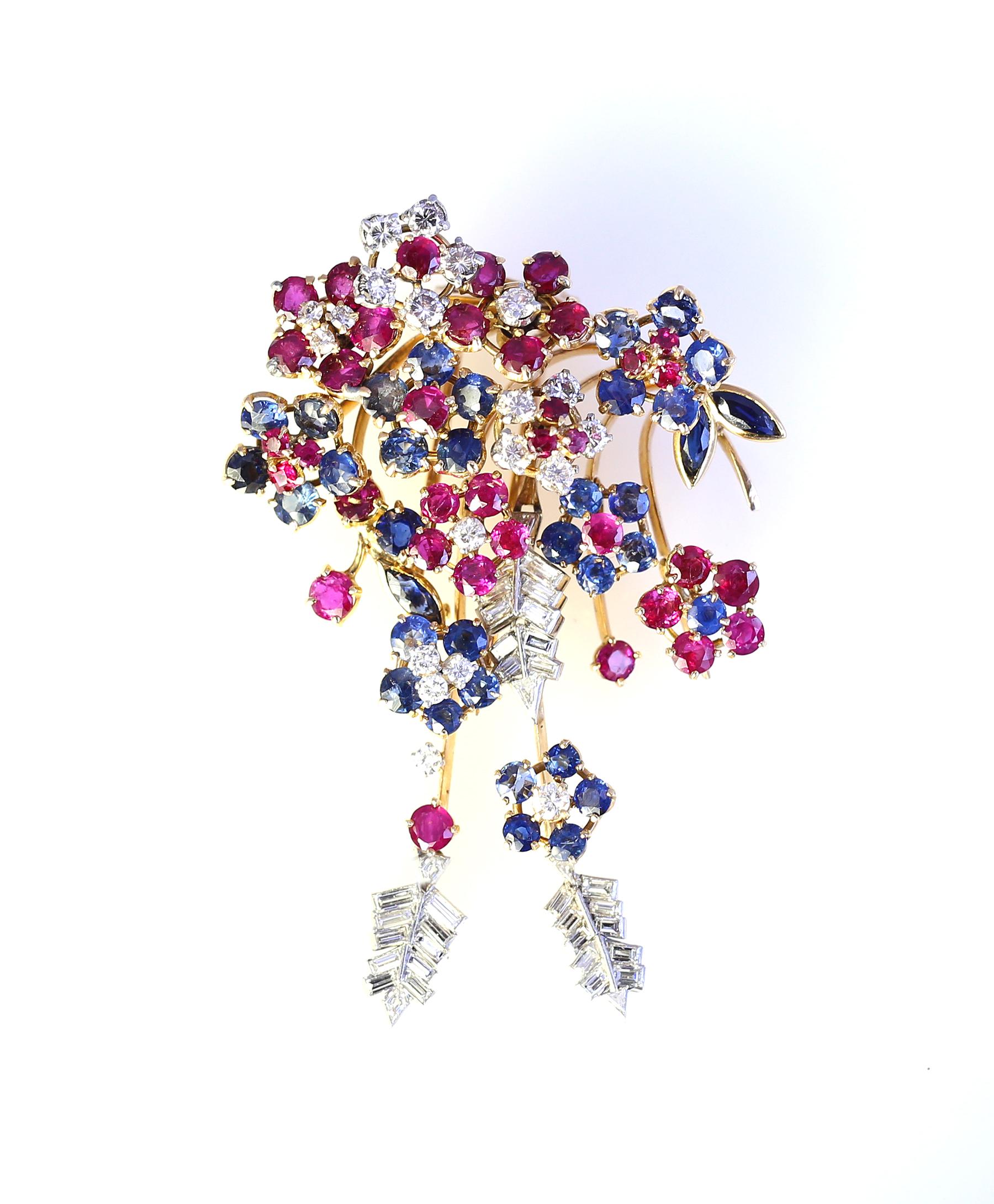 Vintage Platinum and yellow Gold flower bouquet brooch set with Diamonds Sapphires and Rubies. 1950 was a time of rehabilitation in Europe after the great war. Designers were trying to put some colours to the new emerging world. 
Masterfully made