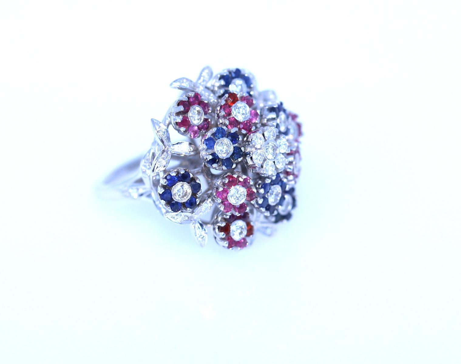 Diamonds, Sapphire and Rubies Ring depicting a Bouquet Moving Flowers. Produced in 2010. 
A ring with a bouquet of moving flowers Diamonds Sapphire Rubies. Amazing craftsmanship of the jeweler. The ring is actually a fine flower bouquet where each