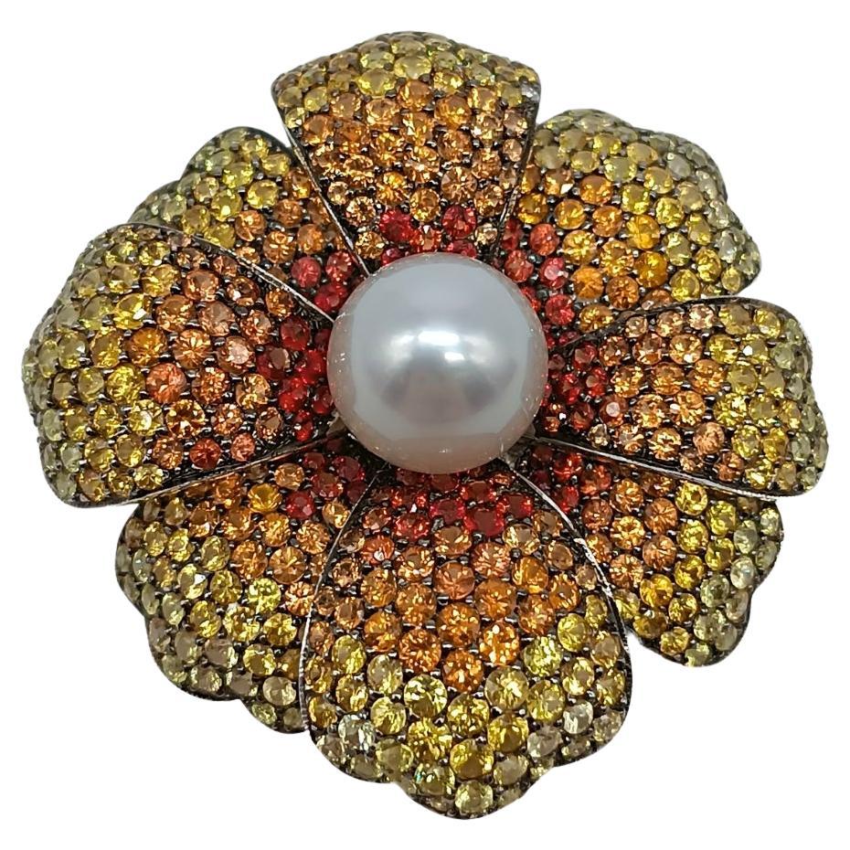 Broche fleur en or blanc avec une perle et des saphirs en vente