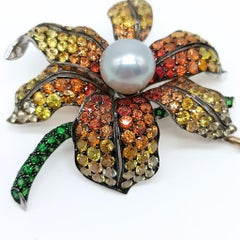 Flower Brooch in White Gold with Pearl, Sapphires and Tsavorites