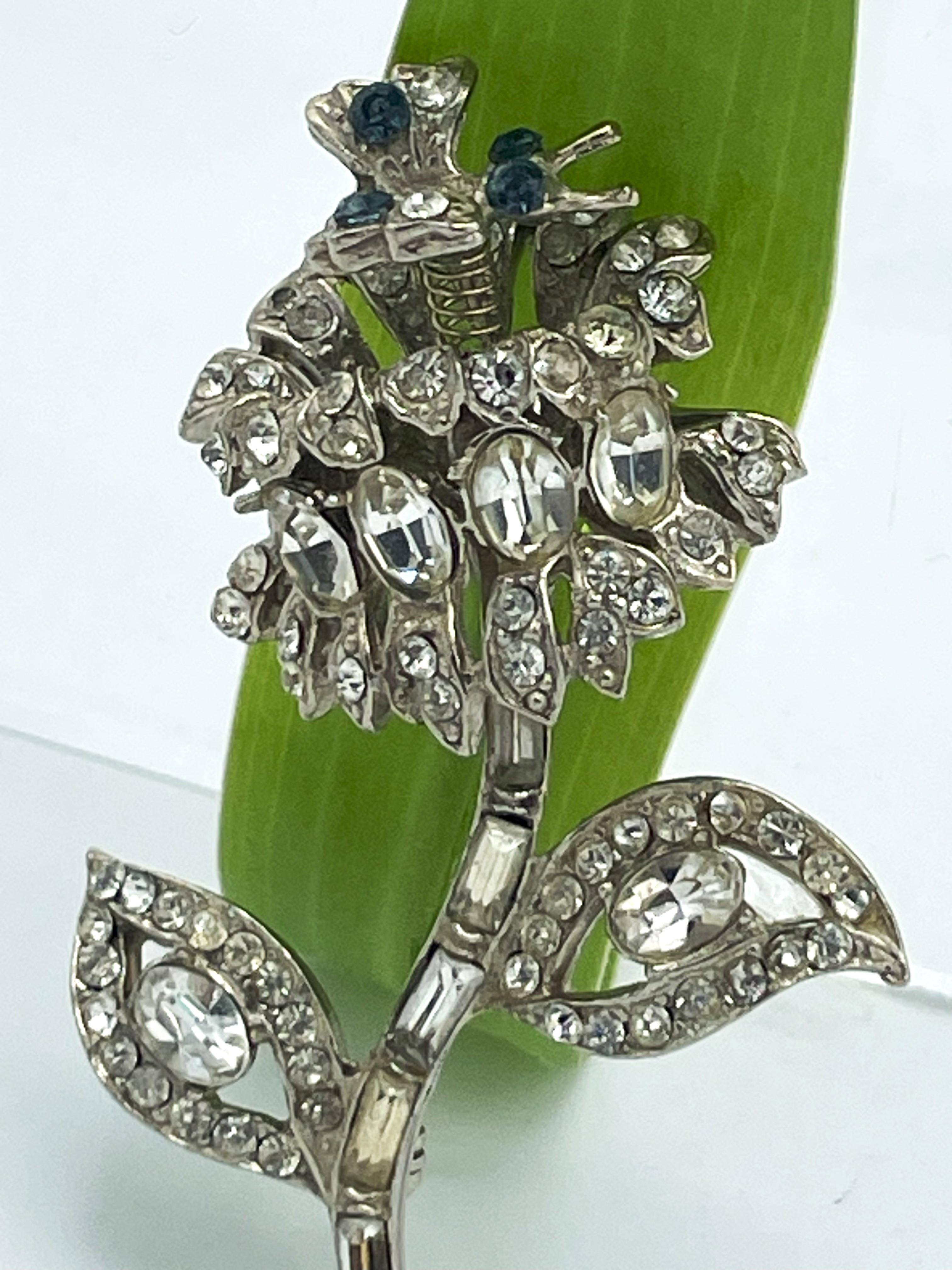 Women's or Men's  Flower brooch with a small moving butterfly, rhinestones, rhodium, 1940 US For Sale