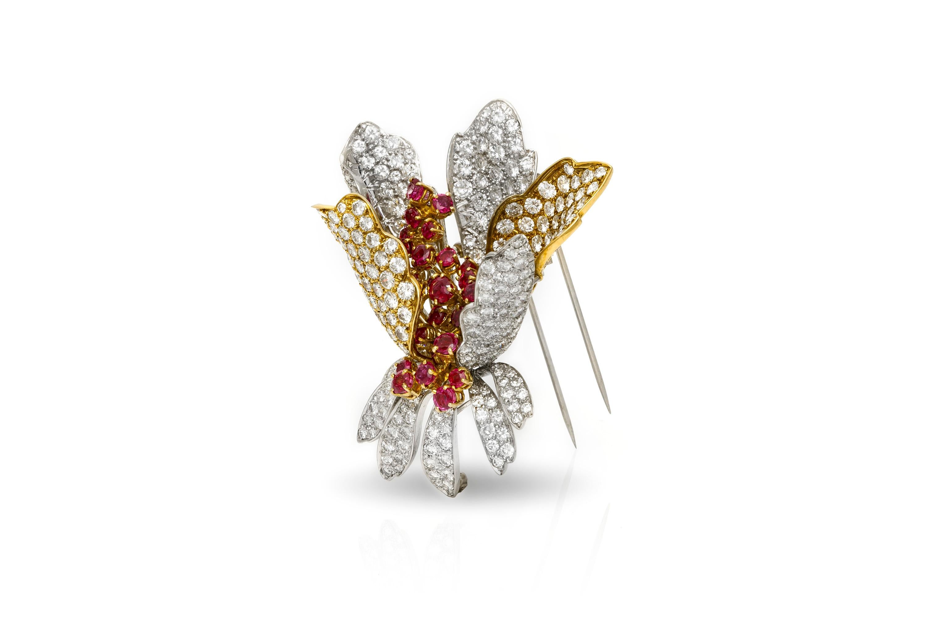 Flower brooch finely crafted in 18k and platinum ,weighing approximately 6.00 carat ruby and approximately 20.00 carat diamond. 
