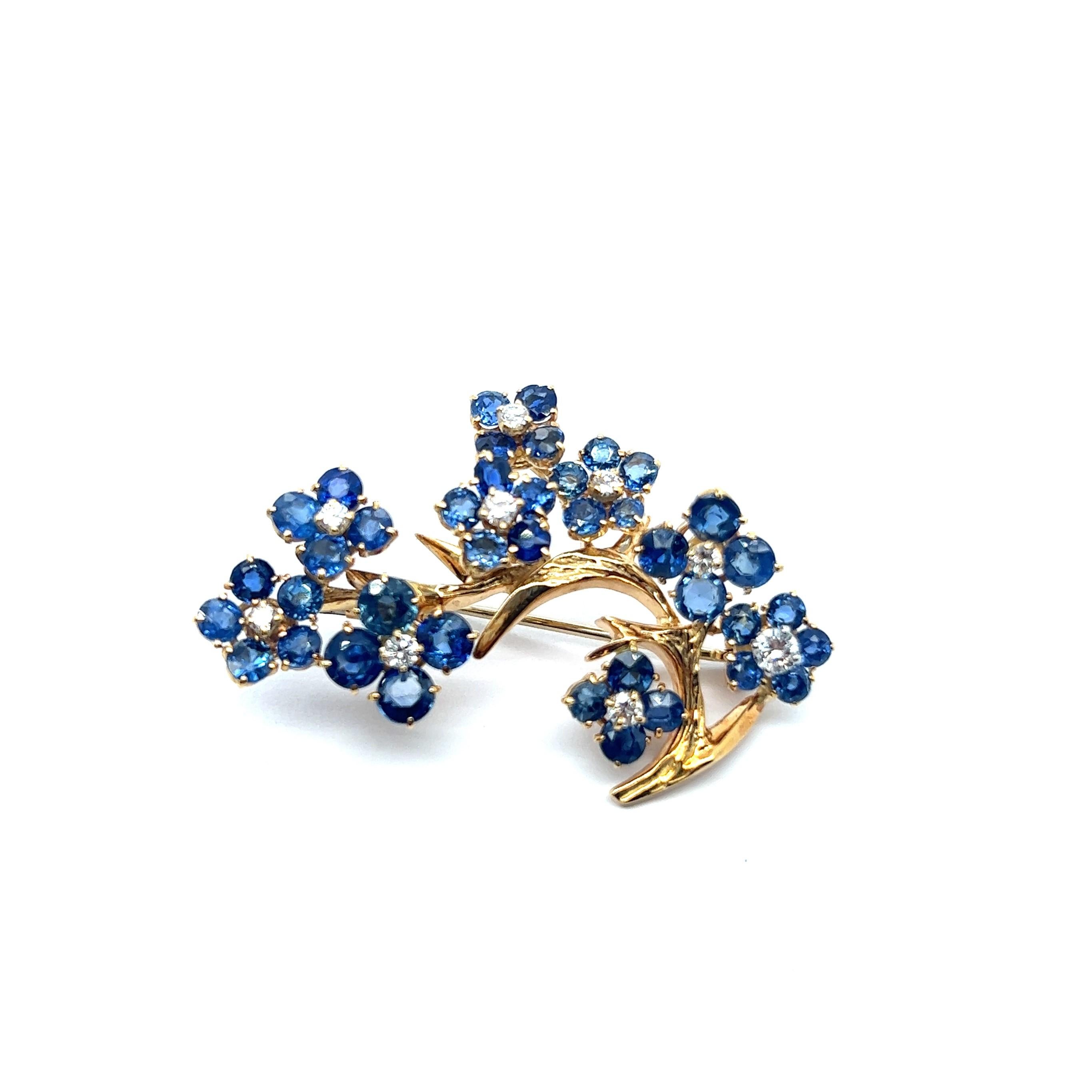 An exquisite brooch with sapphire and diamonds by legendary Swiss Jewelry House Gübelin. The company is celebrated for its illustrious heritage in the world of gemstones and has a legacy spanning generations. 

This golden branch is crafted from 18