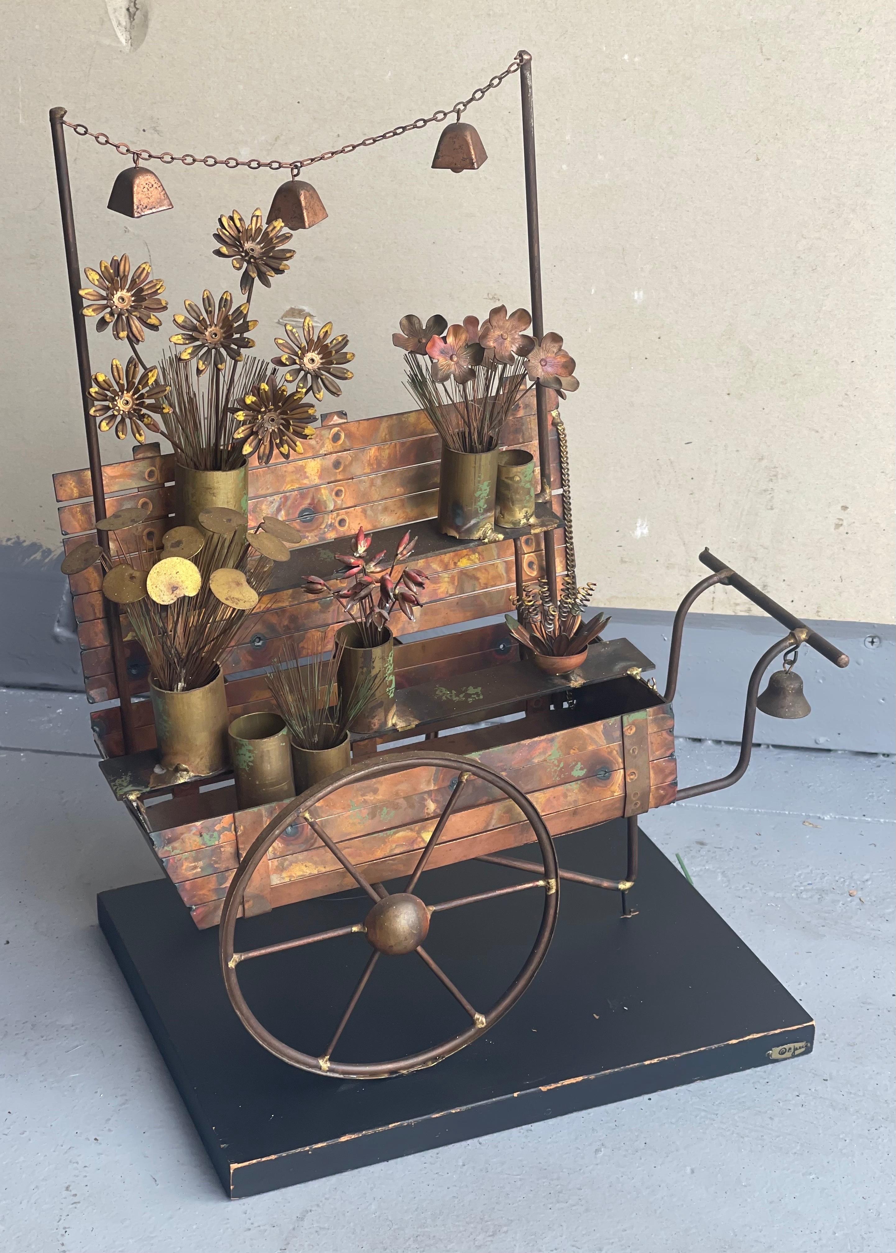 A hard to find mixed metal flower cart sculpture by C. Jere for Artisan House, circa 1970s. The piece has tremendous detail and craftsmanship incuding working bells and measures 13