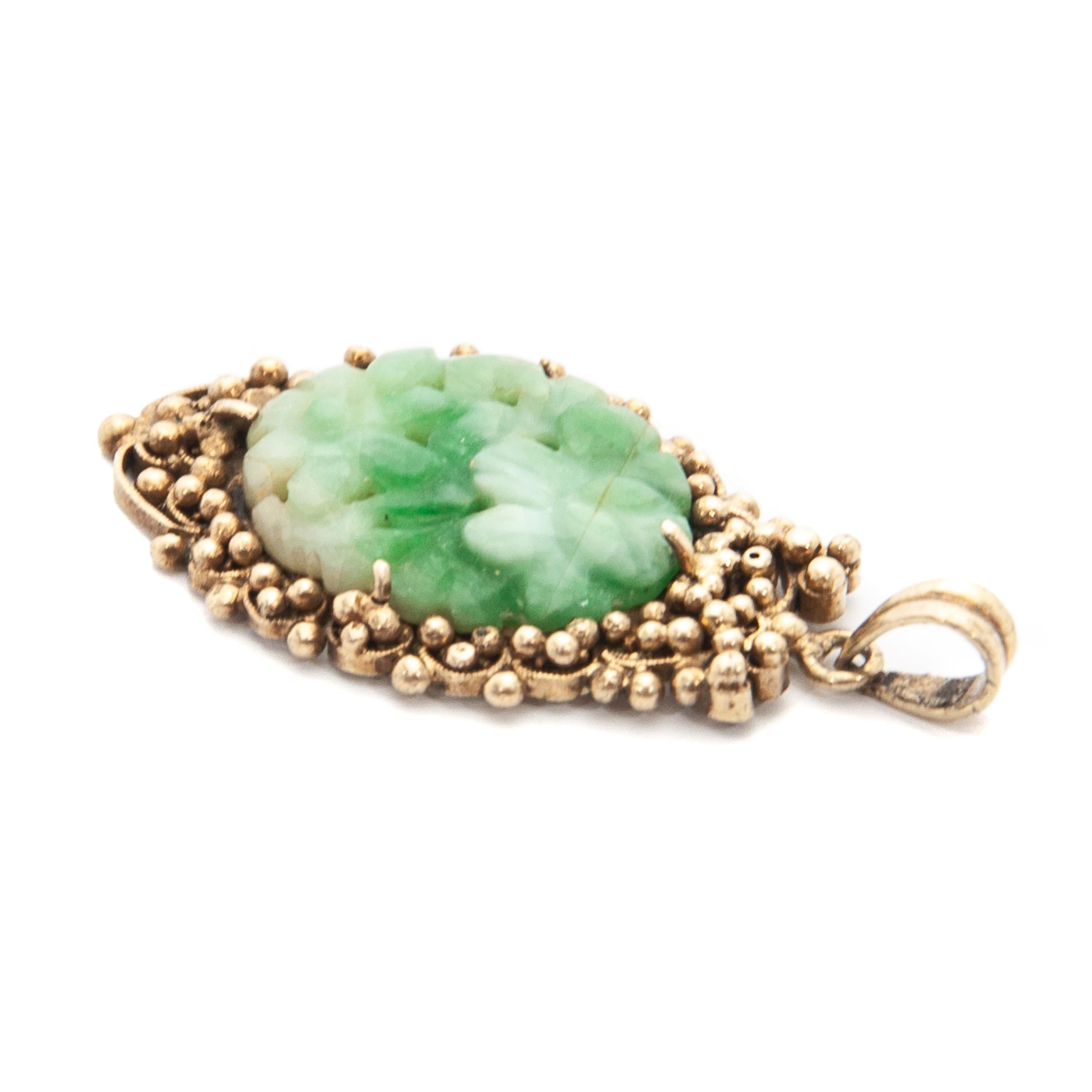 Oval Cut Floral Carved Jade and Gilded Silver Pendant For Sale