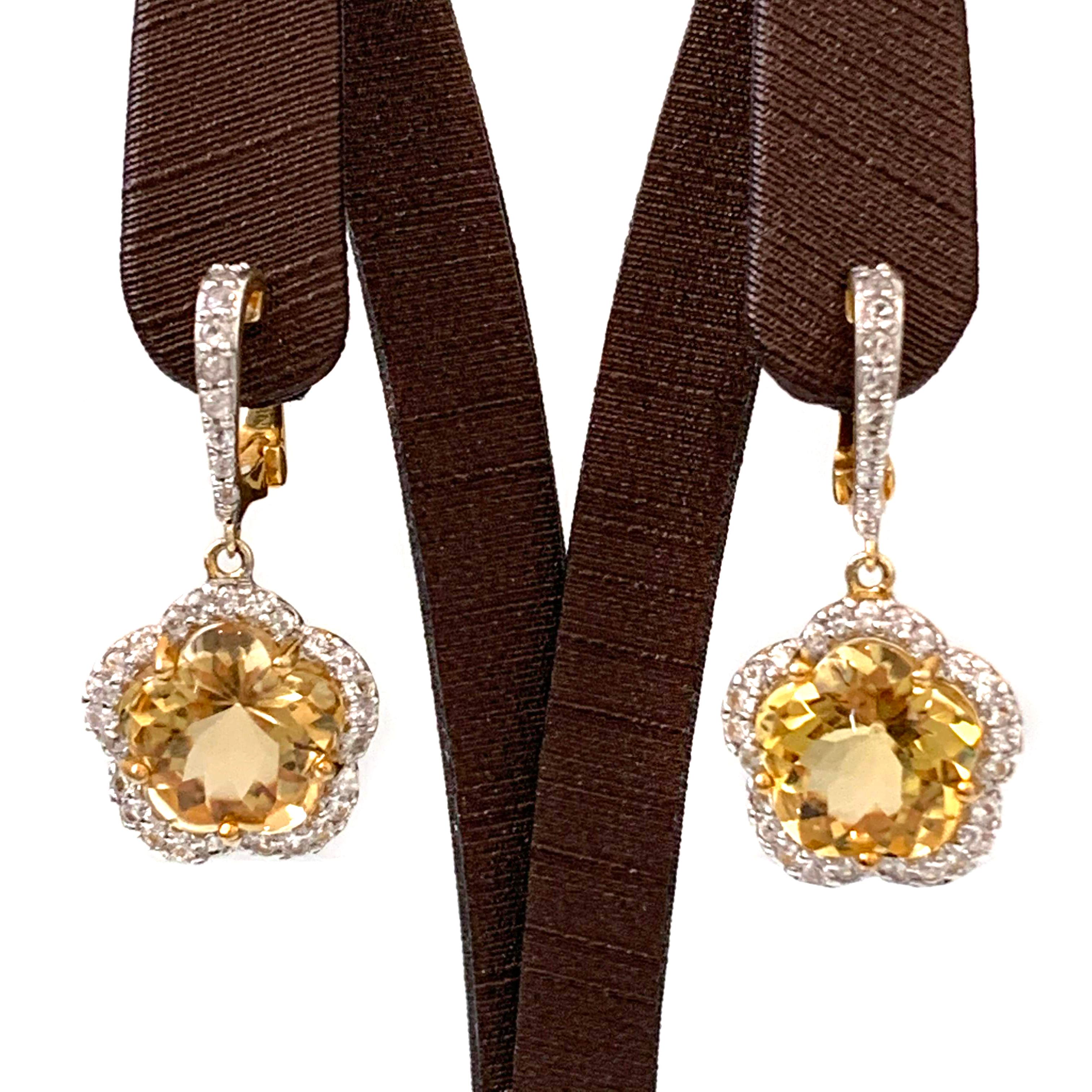Beautiful Flower Citrine & White Sapphire Earrings

The earrings feature 2 beautiful flower-shape cabochon/facet-cut genuine cirine (11mm size, 10ct total), adorned with 70pcs of round white sapphire, handset in 18k vermeil sterling silver. 

The