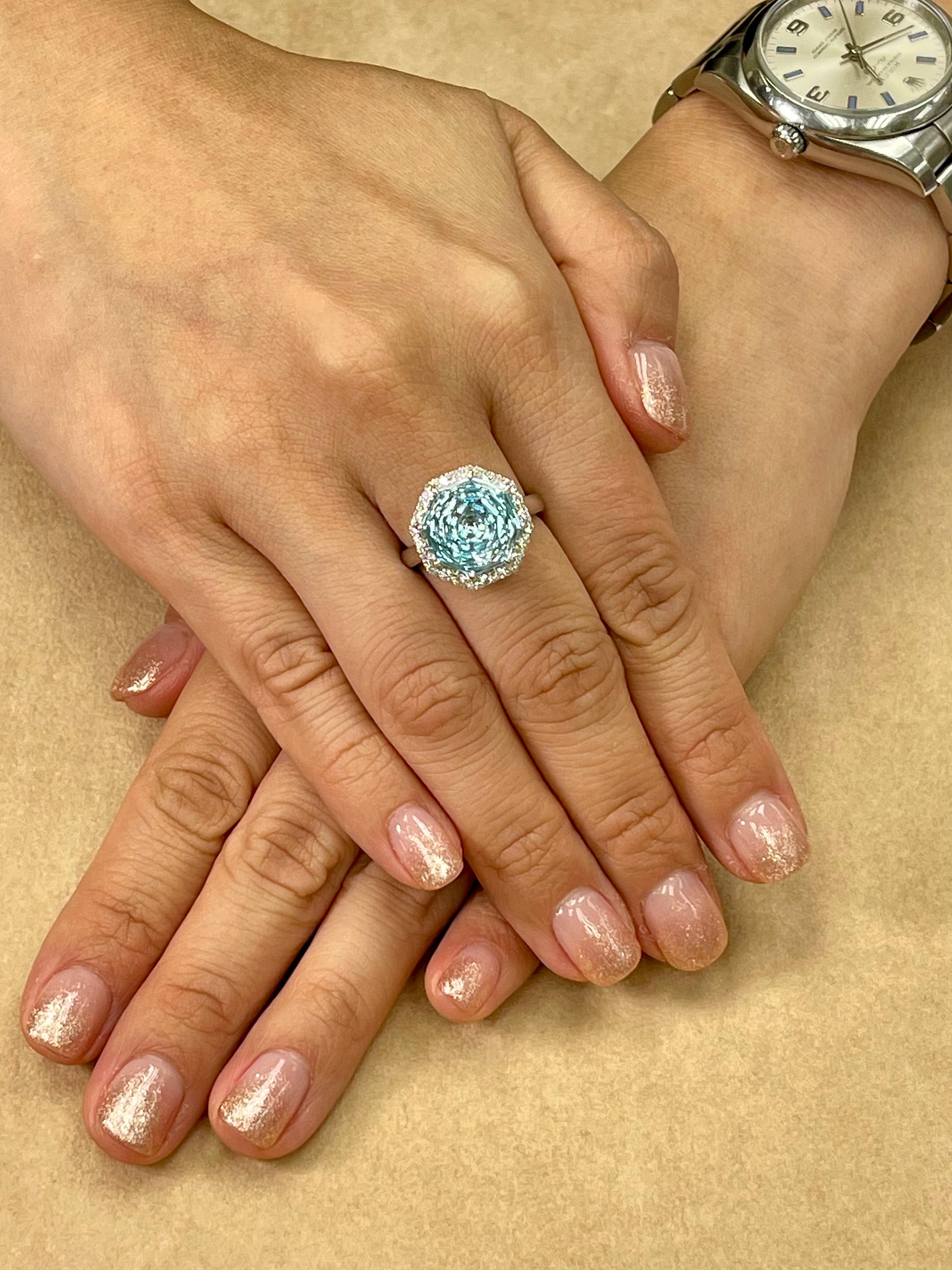 Please check out the HD video! Here is a super unique flower cut powder blue Topaz and diamond cocktail statement ring. It is set in 18k white gold. The 7.86 cts center Topaz is stunning. The flower cut is spectacular and is rarely seen cut to this