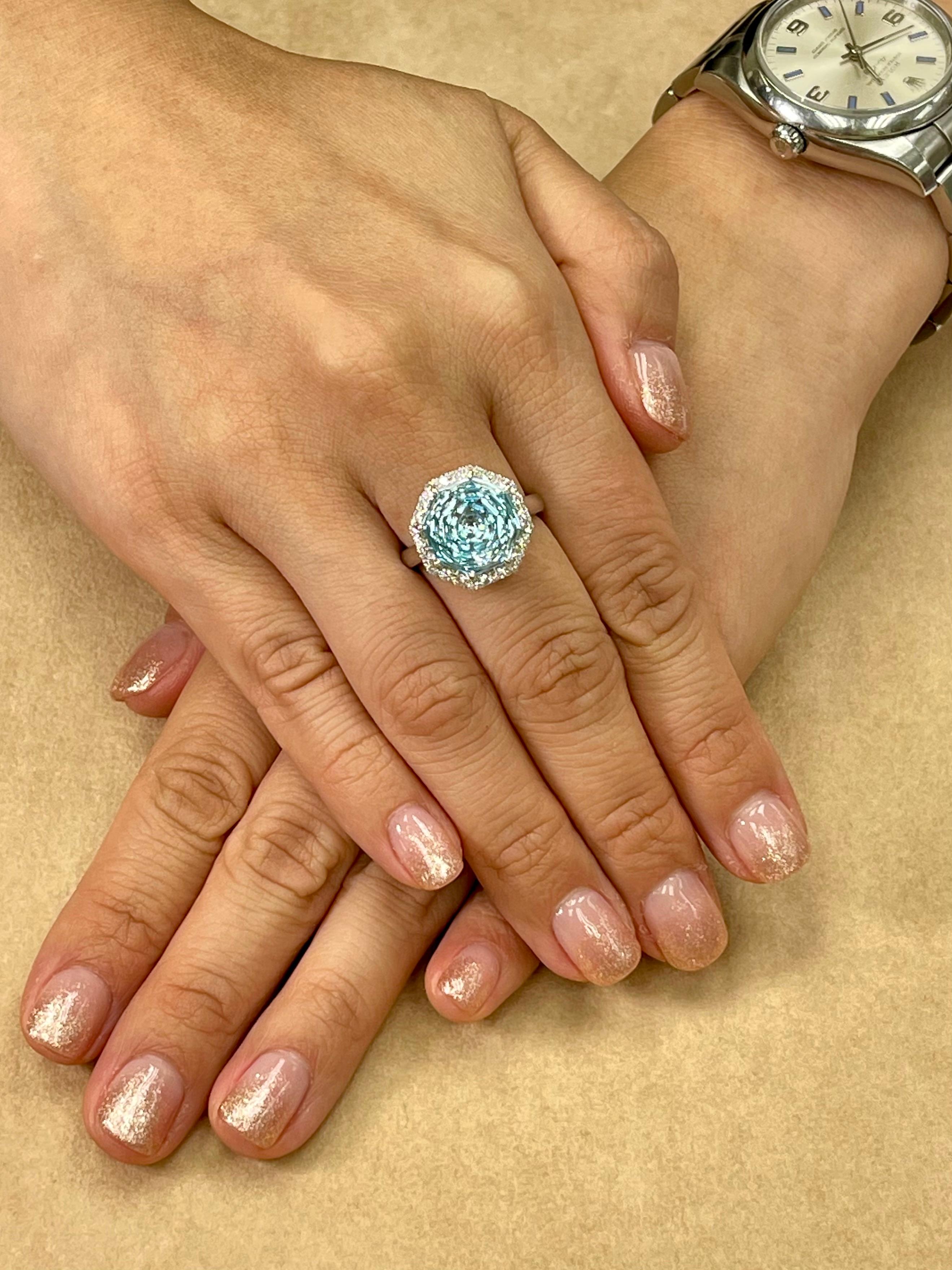Please check out the HD video! Here is a super unique flower / chrysanthemum cut powder blue Topaz and diamond cocktail statement ring. It is set in 18k white gold. The center Topaz 13.5mm is stunning. The flower cut is spectacular and is rarely