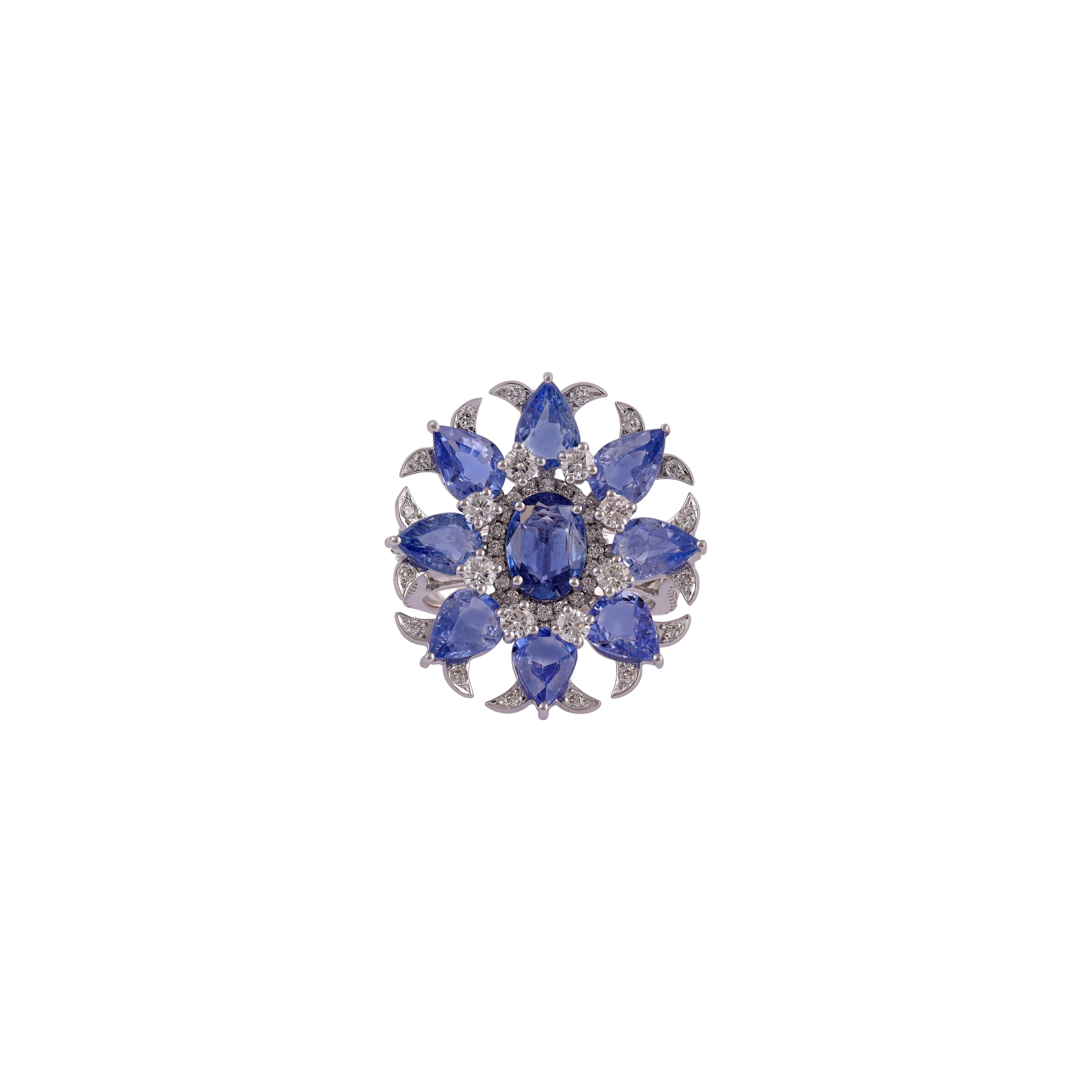 Flower Design Sapphire ring Studded with Diamond in 18k White Gold
1 Oval and 8 Pear shape Blue Sapphire in  7.35 CTS
110 Brilliant cut Diamond 1.31 CTS
Round Diamond 0.25 carat
18K White Gold 6.91 grams

Custom Services
Resizing is