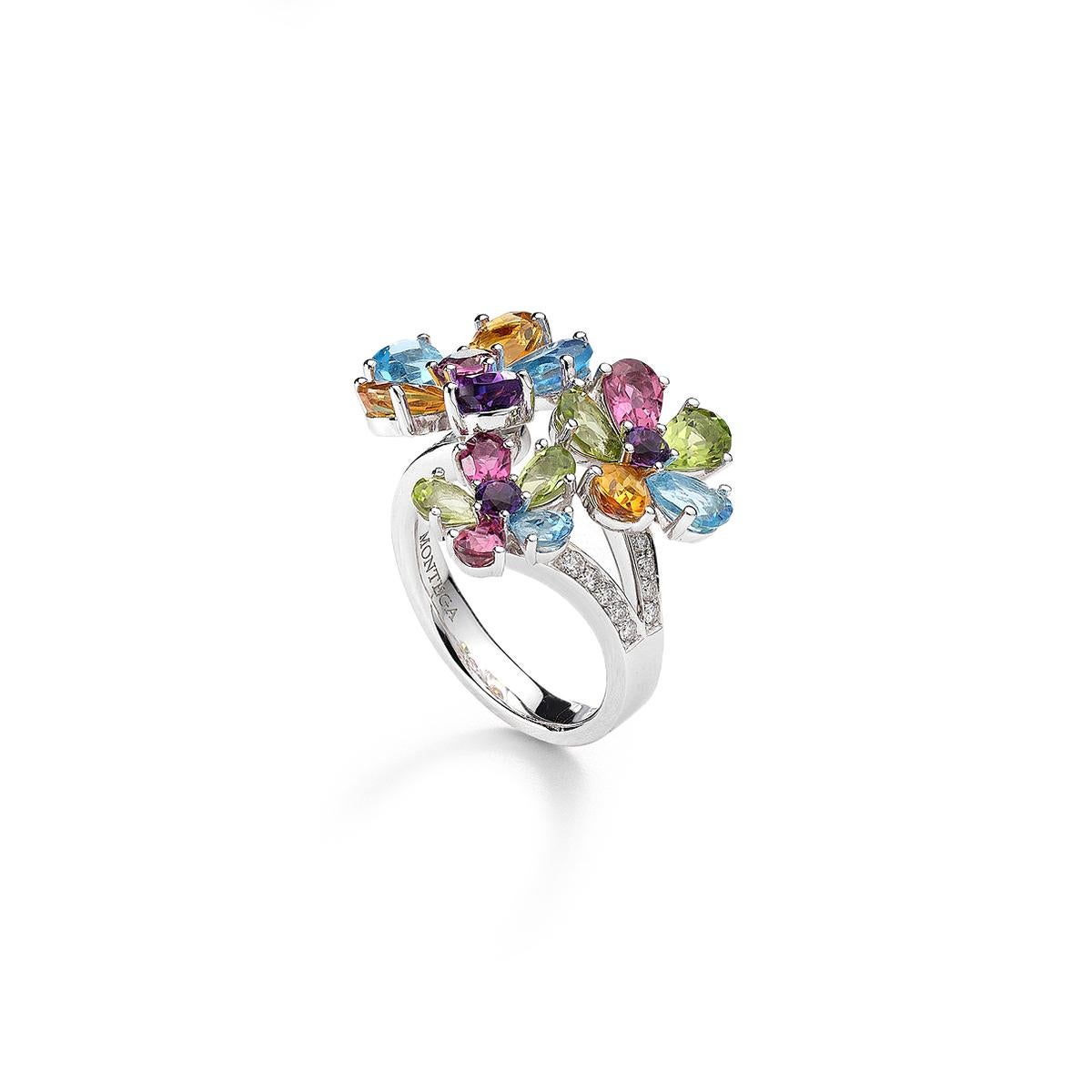 Ring in 18kt white gold set with 14 diamonds 0.19 cts, 4 blue topazes 2.48 cts 3 citrines 1.61 cts, 4 peridots 1.36 cts, 4 toumalines 1.05 cts Size 55 and 3 amethysts 0.87 cts Size 54                   