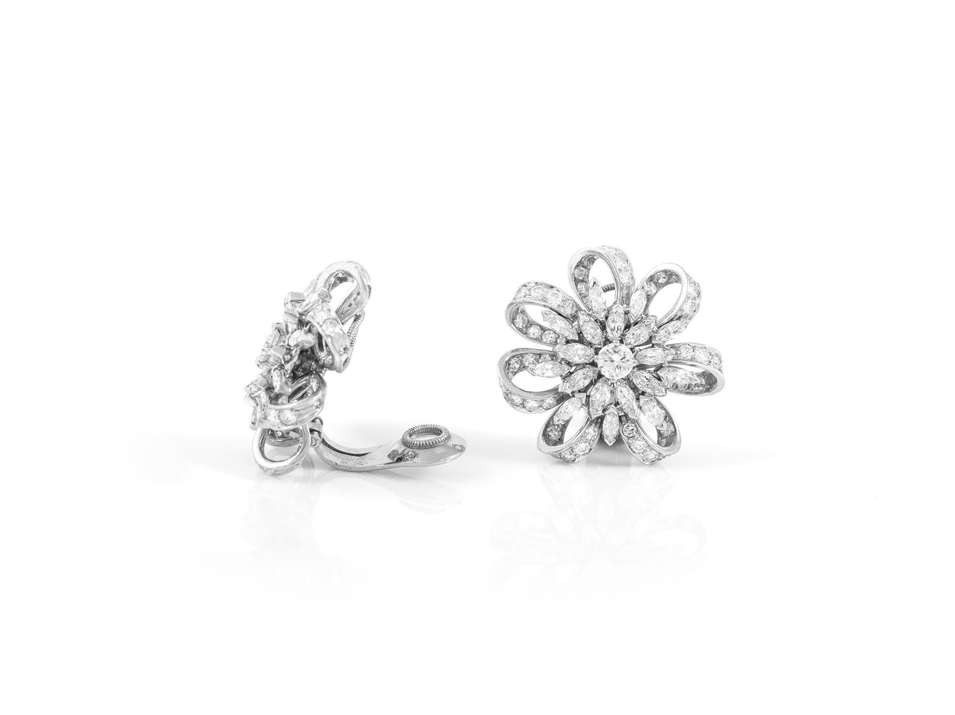 Flower diamond ear-clip earrings, finely crafted in platinum with marquise and round brilliant cut diamonds, weighing a total of approximately 9.00 carat.