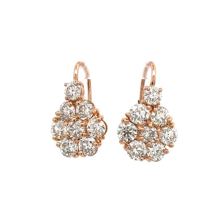 Indulge in the captivating allure of our exquisite round-cut diamond flower earrings, an absolute must-have accessory for every fashion-forward individual. These meticulously crafted lever-back earrings showcase a dazzling ensemble of eight white