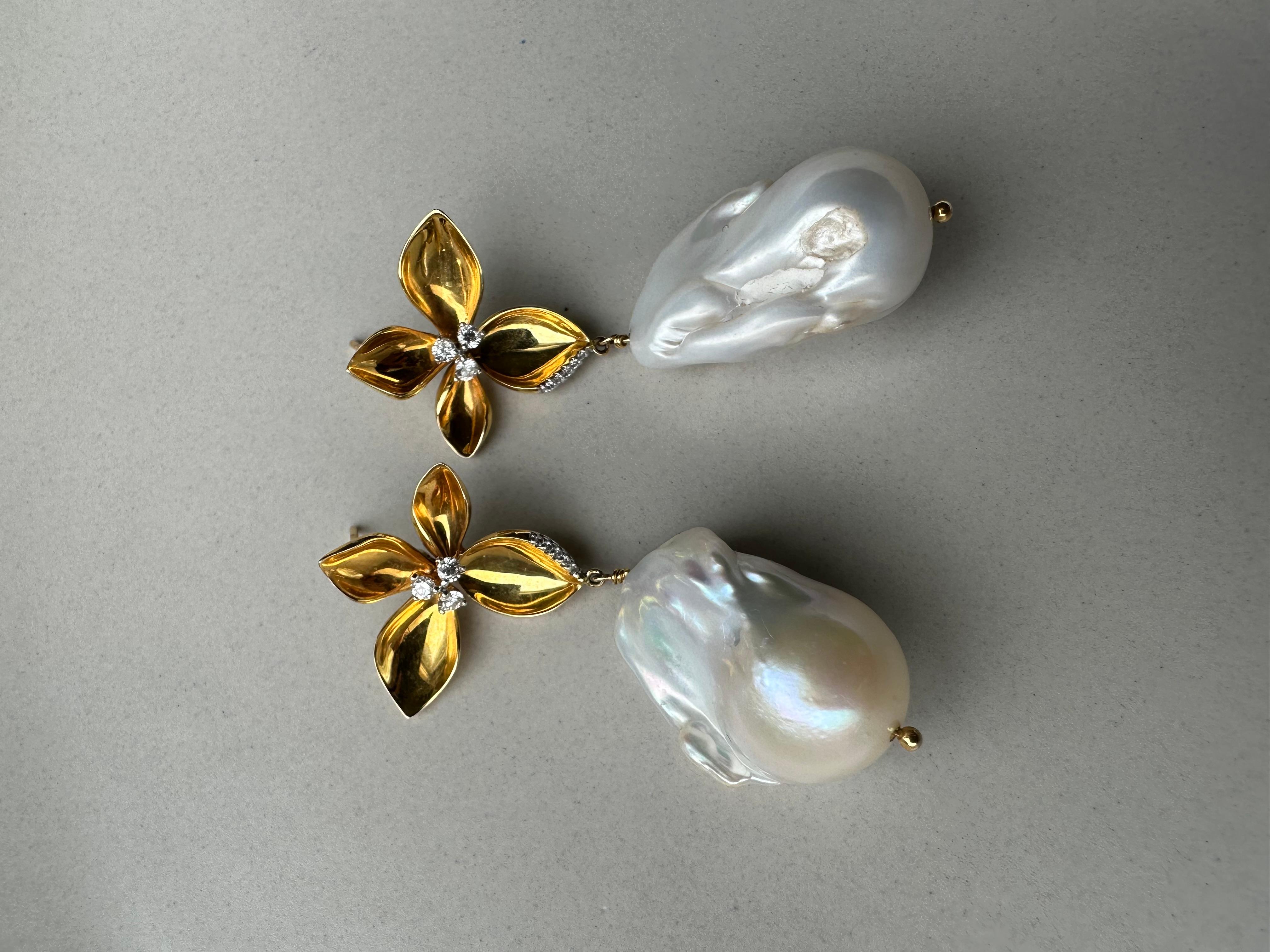 Crown Jewel of the Renaissance Collection.

Meticulously handcrafted floral design exudes a refined yet playful look.

Lustrous gold petals surround the diamond for that extra shimmer.

Finished with dangling Baroque pearl to make it the show
