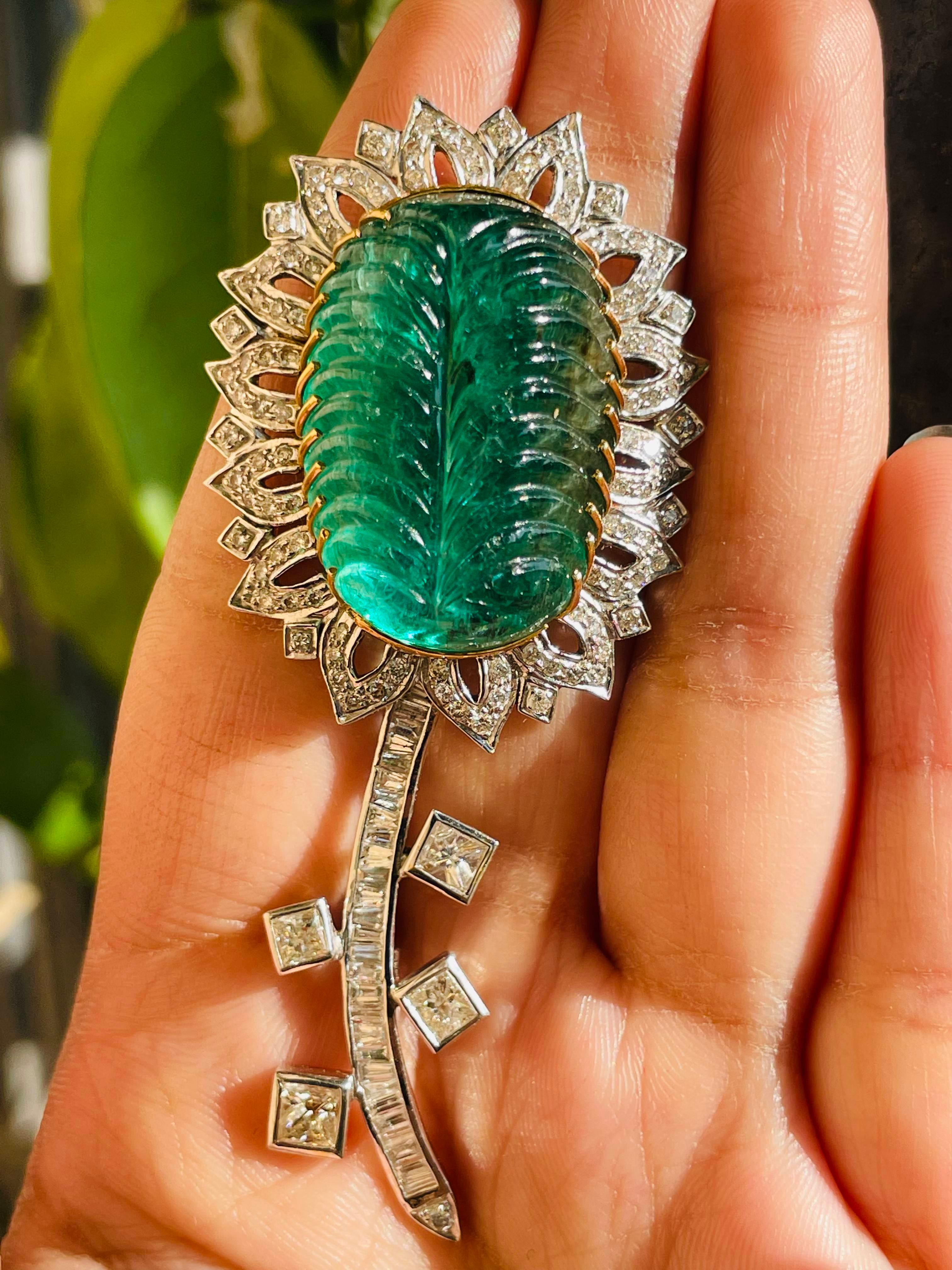 55 Carats Emerald Diamond Floral Brooch Made in 18k Gold which is a fusion of surrealism and pop-art, designed to make a bold statement. Crafted with love and attention to detail, this features 55 carats of emerald which makes you stand out of the