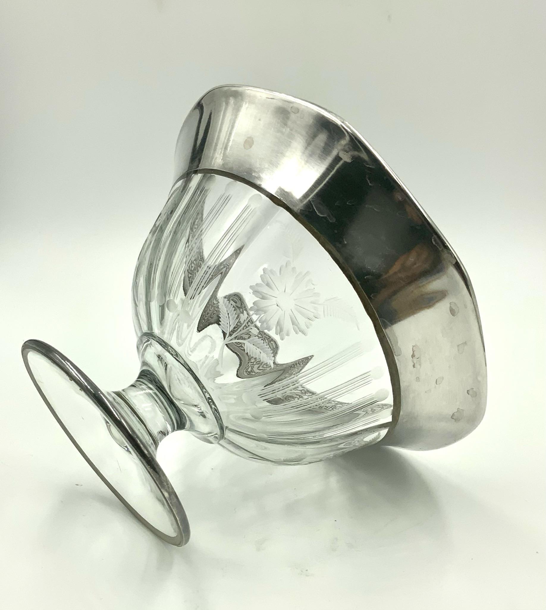 Mid 20th century etched glass footed compote bowl decorated with 4 flower panels divided by 4 line and dot panels. The top has a thick leaf and vine silver 1.35