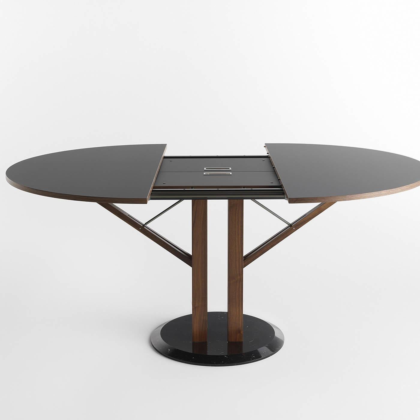 This superb and extremely modern table is a functional piece of design that can extend to a maximum total measure of 178 x 120 x H 75 cm. It features a top and extensions made of Fenix NTM, a new material whose surface features a low-reflective