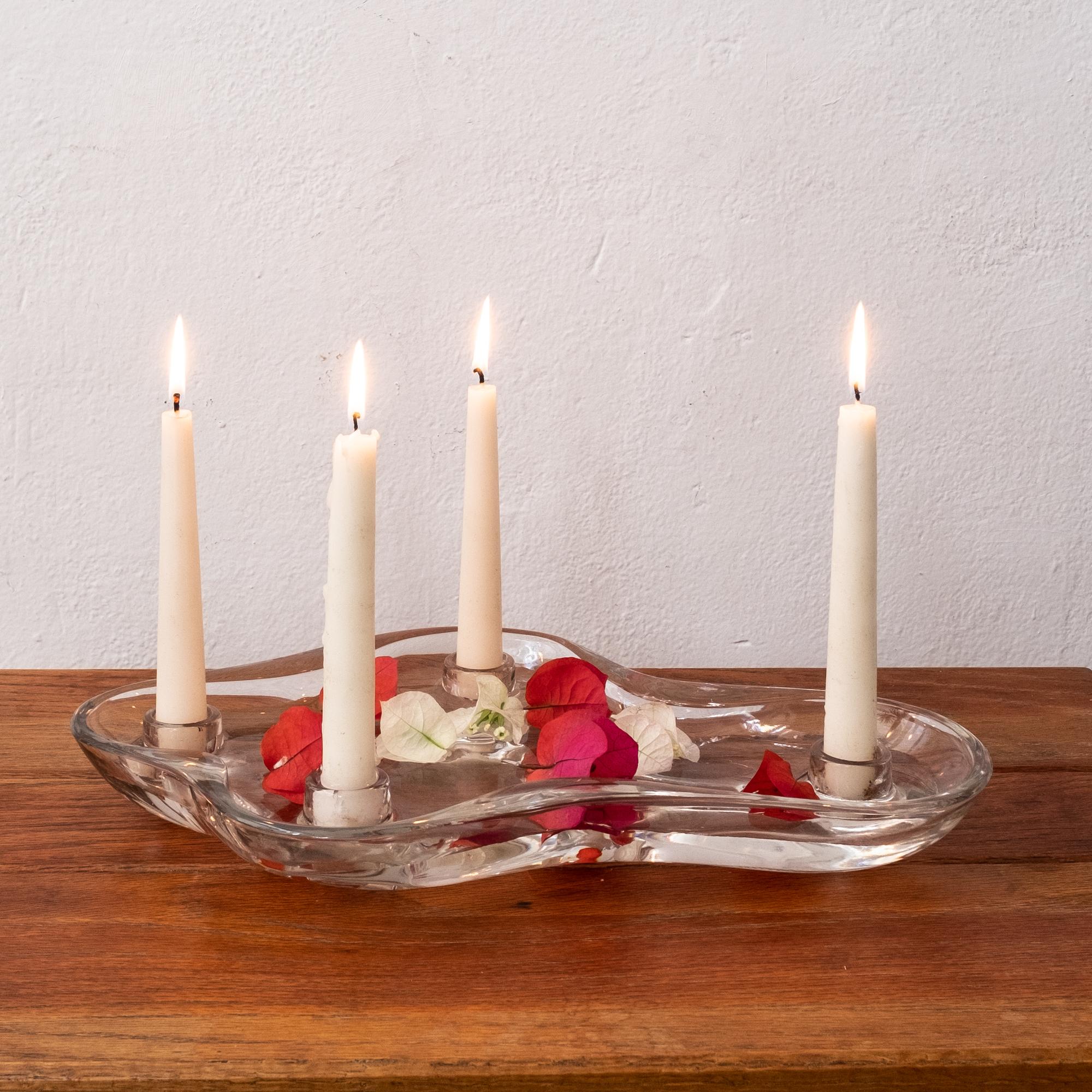 Flower Floater candleholder designed by Eva Lisa (Pipsan) Saarinen Swanson and manufactured by U.S. Glass Company in 1948. 

Eva Lisa (Pipsan) Saarinen Swanson is part of an influential design family. Her father was the architect and designer