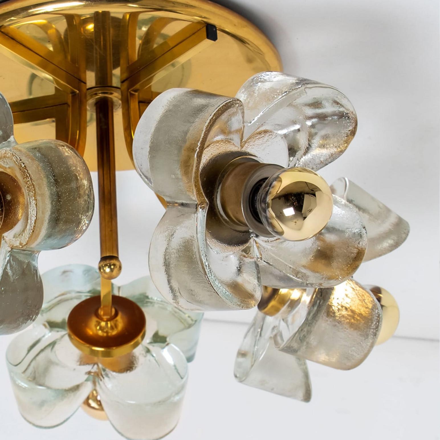 A wonderful flower flush mount by Sische Lighting, circa 1970s, Germany.
The flush mount is composed of six glass flower shades attached to a round brass base. High end piece from the 20th century.

The flush illuminates a warm-light due to the