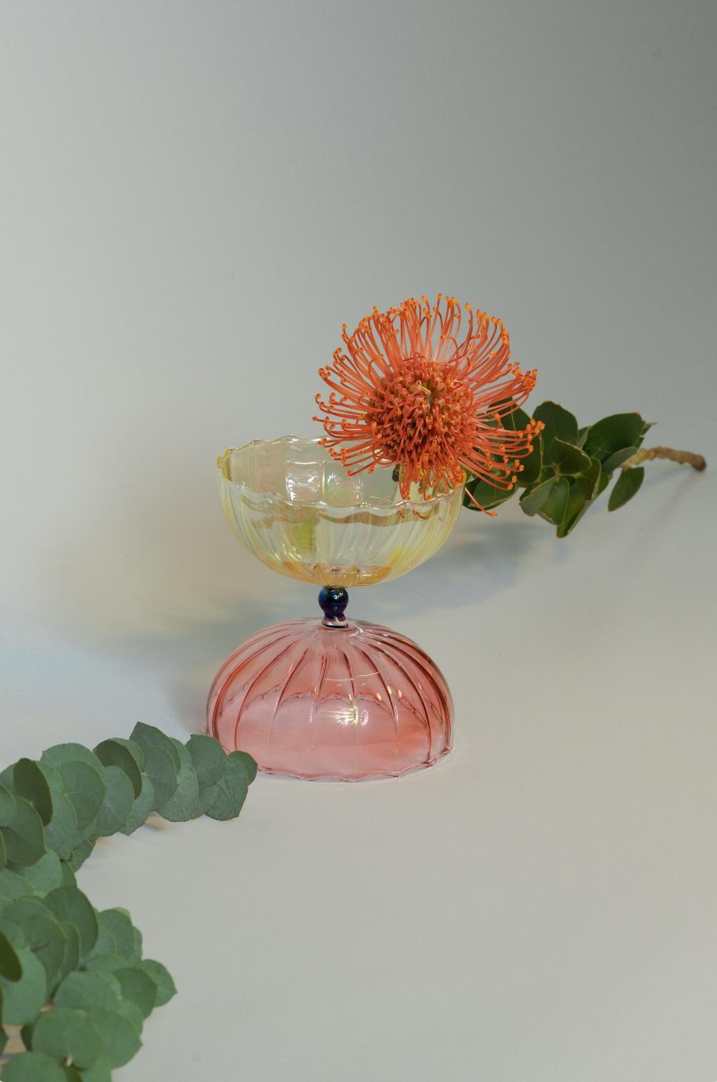 Hand blown flower vase made in Italy. Delicate colors and soft shapes makes this object the perfect one to welcome you in your home and leaves in your coins or keys.
