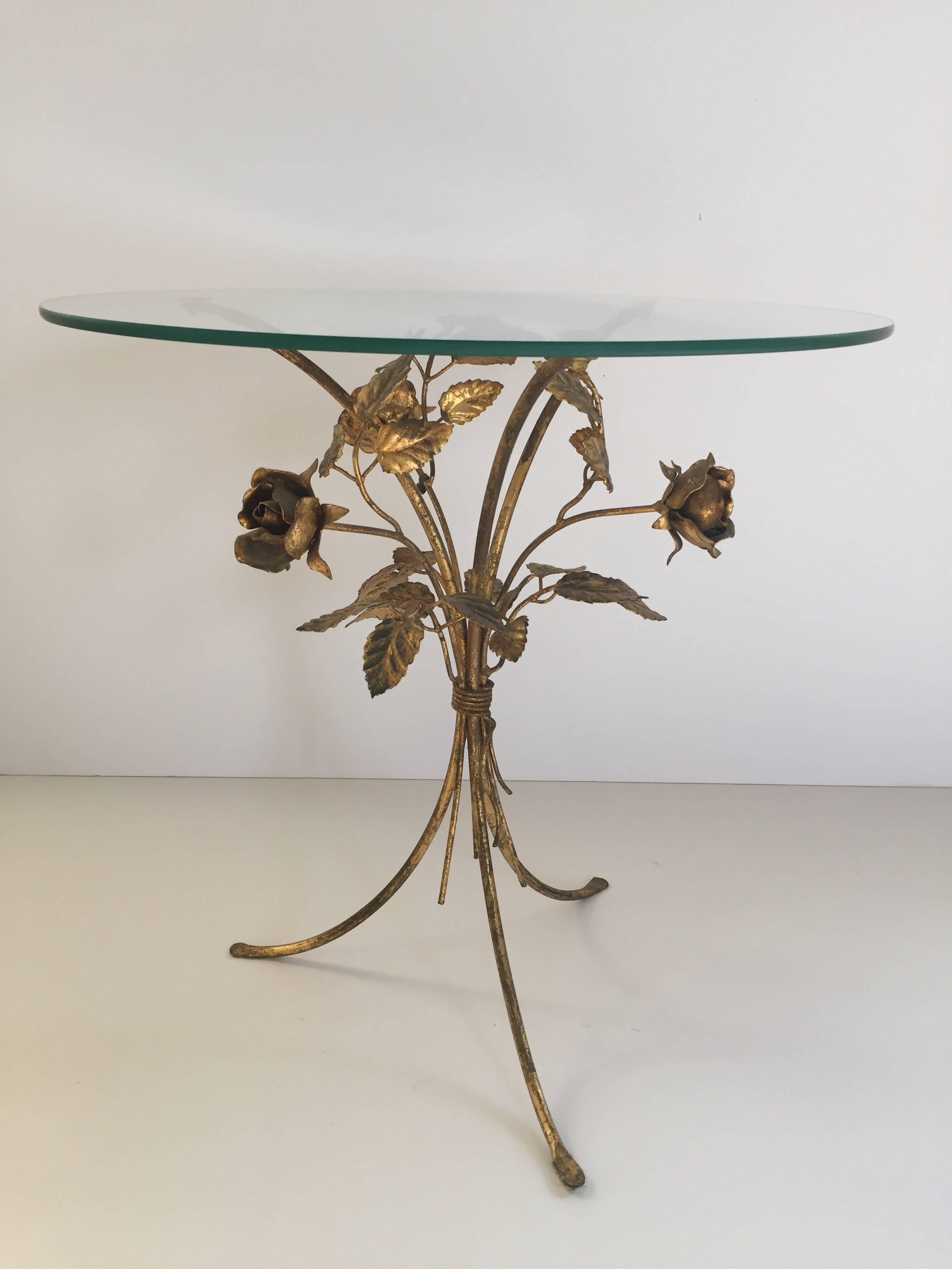 Mid-Century Hollywood Regency Gilt Metal Leaf and Flower Side Table by Hans Kögl
Flower side table on a tripod base with flower details by Hans Kögl.
Midcentury side table with a round glass top seating on a gilt metal tripod base.
Hollywood Regency