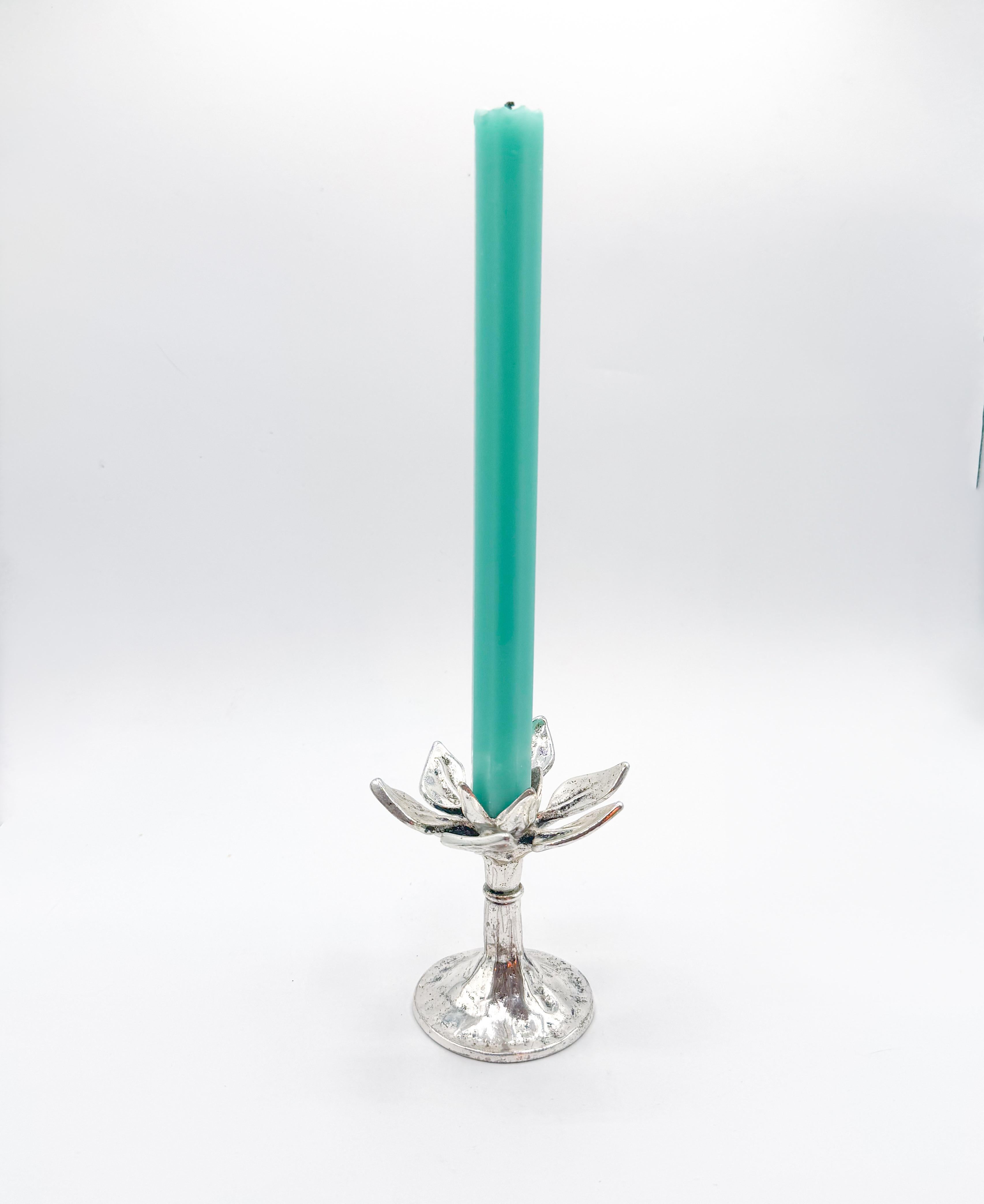 This vintage Italian candlestick holder features an elegant open-lotus design with layered petals rising from a sculptural base. Cast in richly textured silver-toned metal, the piece has a refined organic form that recalls Art Nouveau motifs while