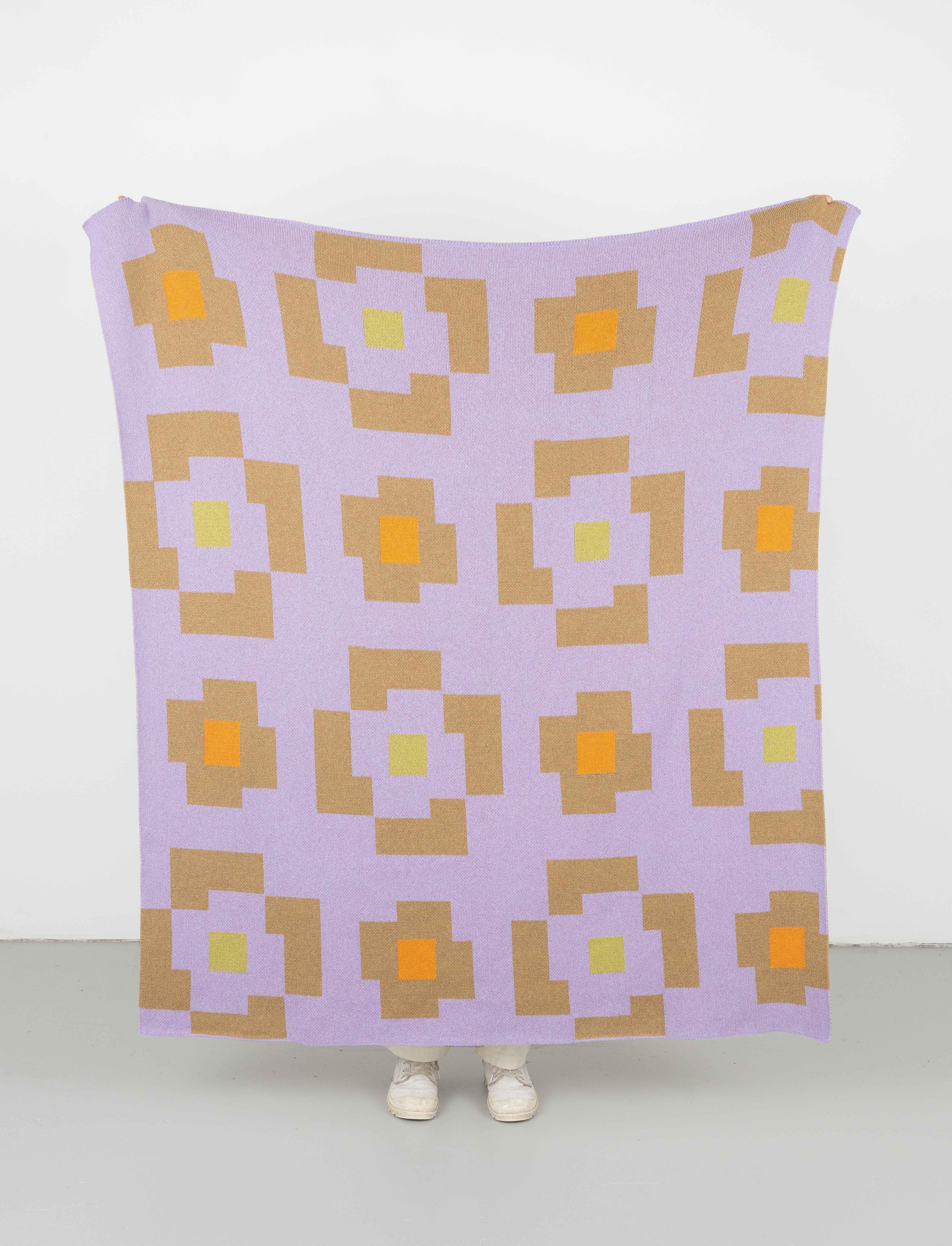 Flower Throw comes in three punchy colorways with a design inspired by early 19th century Overshot Novelty weave patterns.

Knit with 100% upcycled and recycled materials. With a heavier weight and softer hand than our woven throws, the drape and