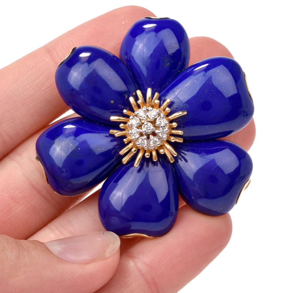 This elegant stylish floral lapis lazuli and diamond pin brooch is crafted in solid 18K yellow gold. Pin brooch displays 6 statement lapis lazuli petals adorned by a 9 round face prong set diamond flower bud approx. 0.20 carats, H-I color, VS