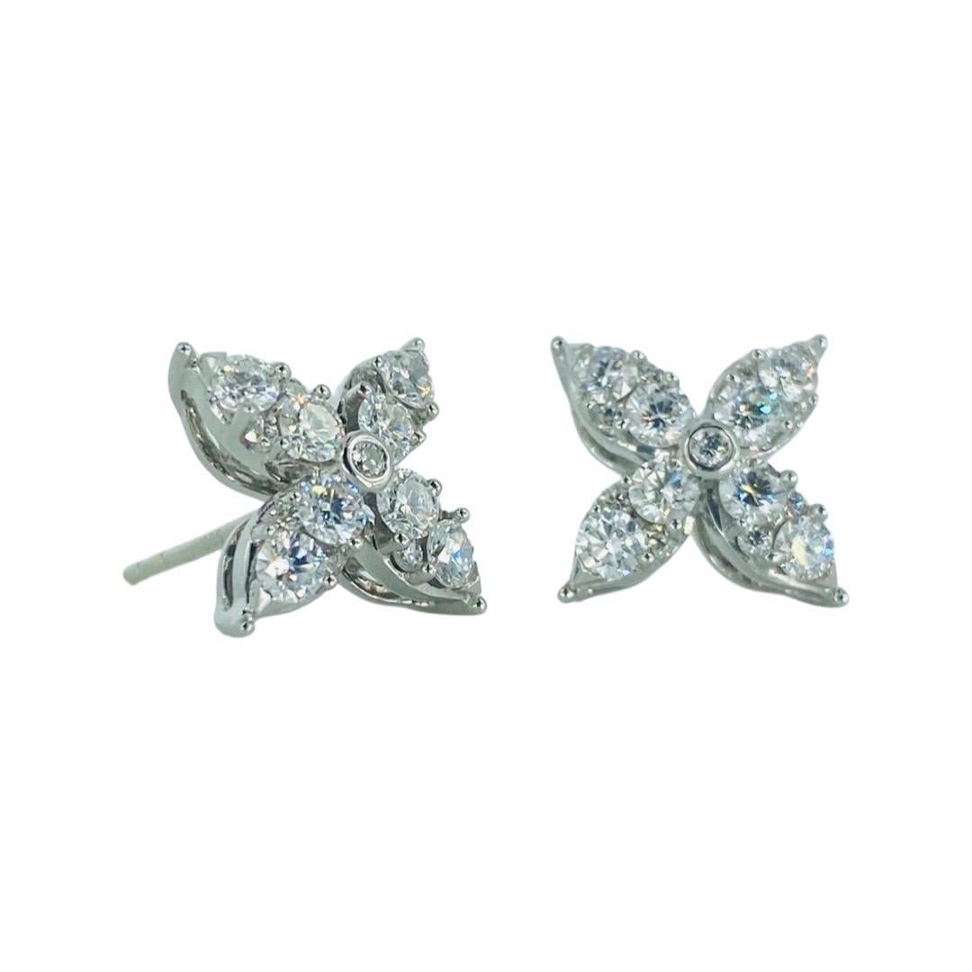Flower Leaf 1.00 Carat Diamonds Stud Earrings 14k White Gold. Beautiful designers stud diamond earrings featuring round cut diamonds bezel set and prong set. The diamonds featured are F-G color and VS clarity natural earth mined diamonds. The