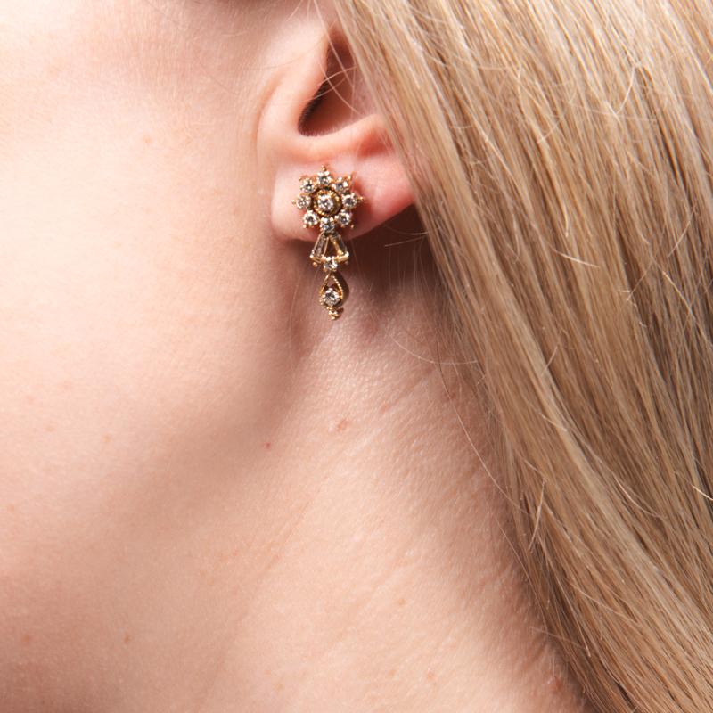 Diese sehr von Bridgeton inspirierten Ohrringe mit zierlichem Blumenmotiv weisen ein Gesamtgewicht von ca. 1,05 Karat an natürlichen runden, geraden und spitz zulaufenden Baguettes auf. Sie sind in 14k Gelbgold gefasst.
Sie eignen sich sowohl für