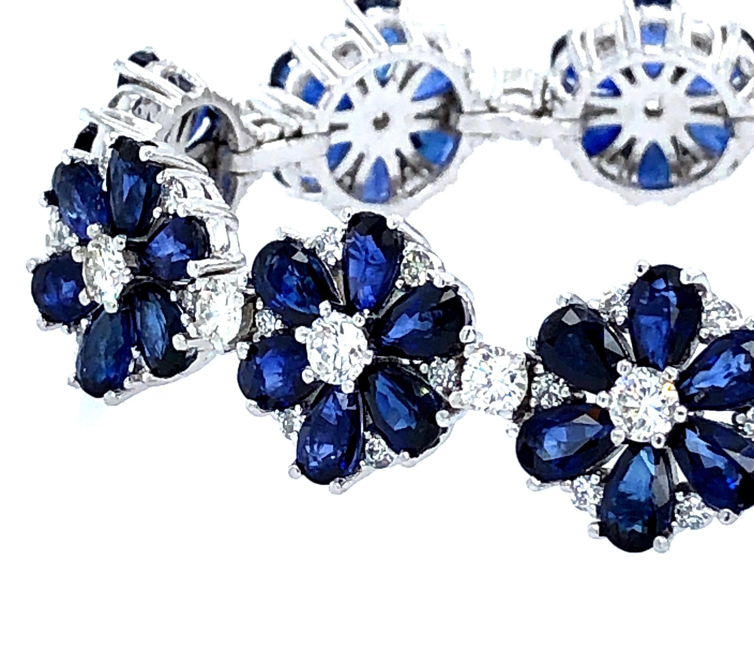 Offered here is a stunning sapphire and diamonds flower motif bracelet set in platinum. The bracelet has 14 links with all stones prong set. The bracelet has natural pear shape sapphires with a estimated total weight of 18 carats. The sapphires are