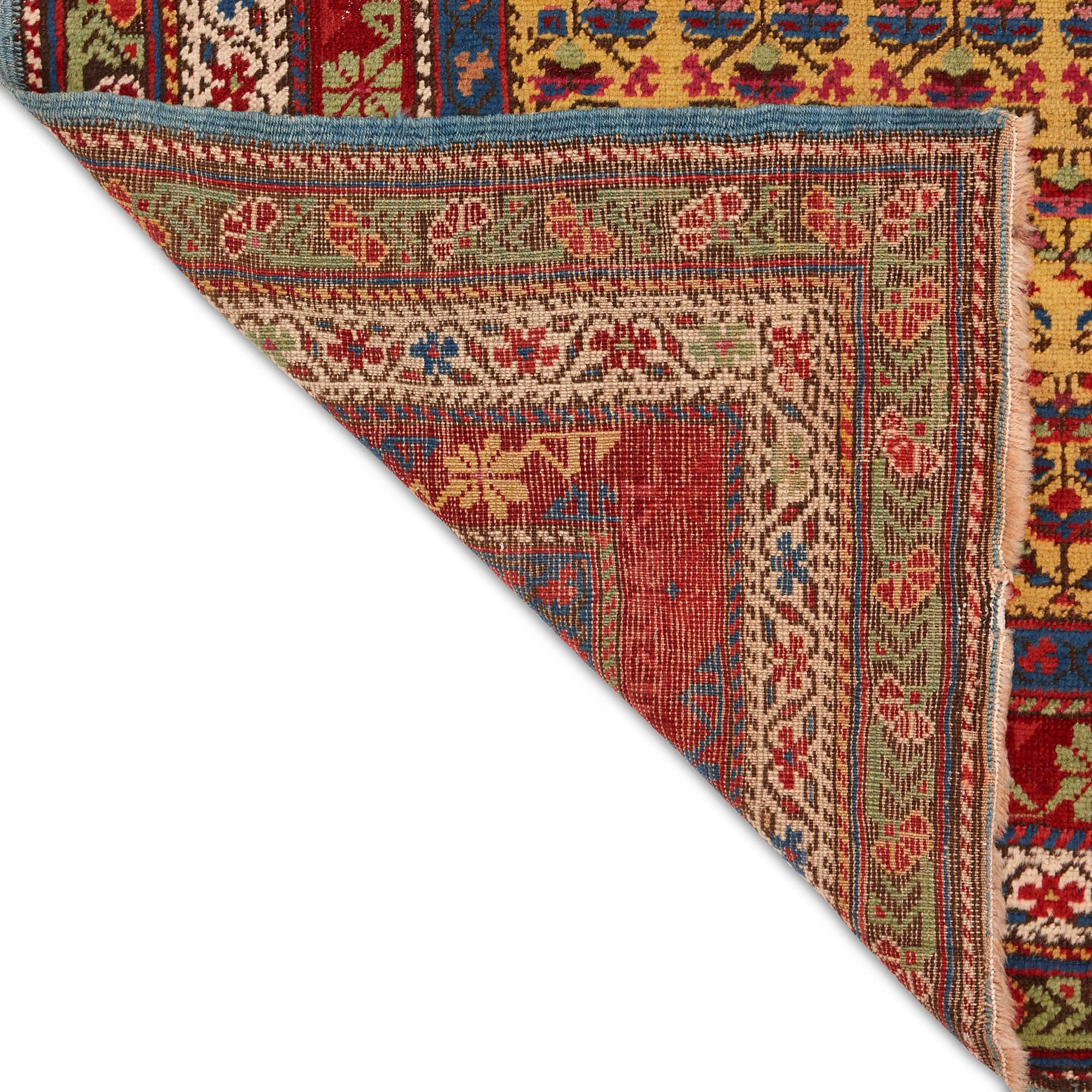 Flower motif Seychour Caucasian runner
Caucasus, 20th Century
Height 338cm, width 100cm

This intricately designed Seychour runner showcases the signature precision and saturation of its origin. 

The rug’s muted, dark yellow central panel is